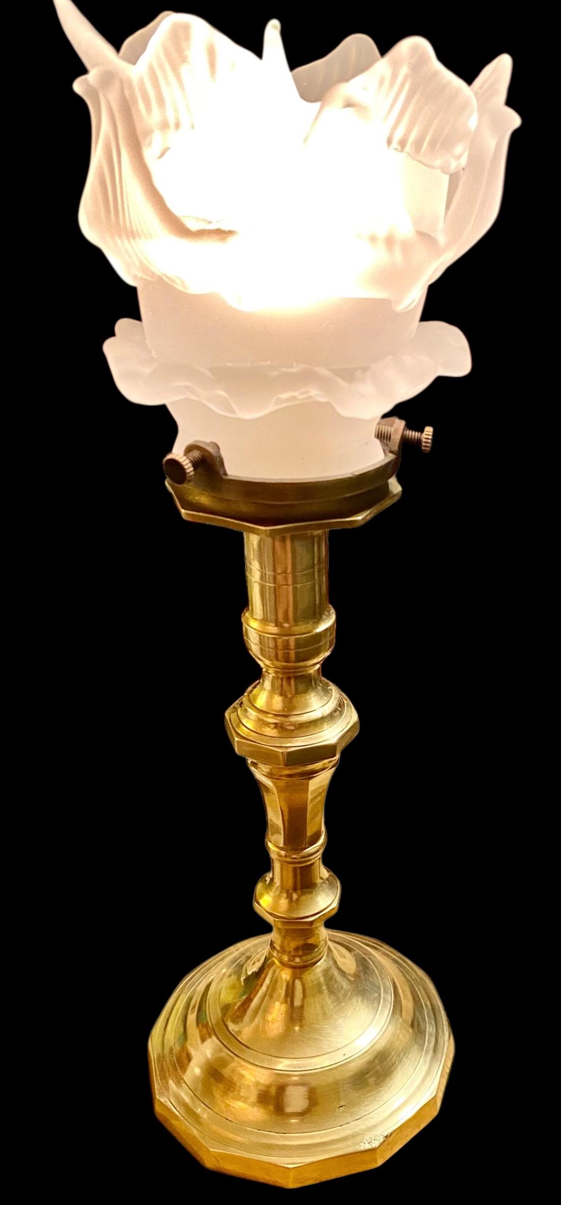An antique French Belle Epoch solid brass candlestick lamp having a lovely frosted glass leaves shade, the brass having a beautiful soft glow. 
Newly rewired with an on and off in line switch and a new American chandelier socket. Comes with a small