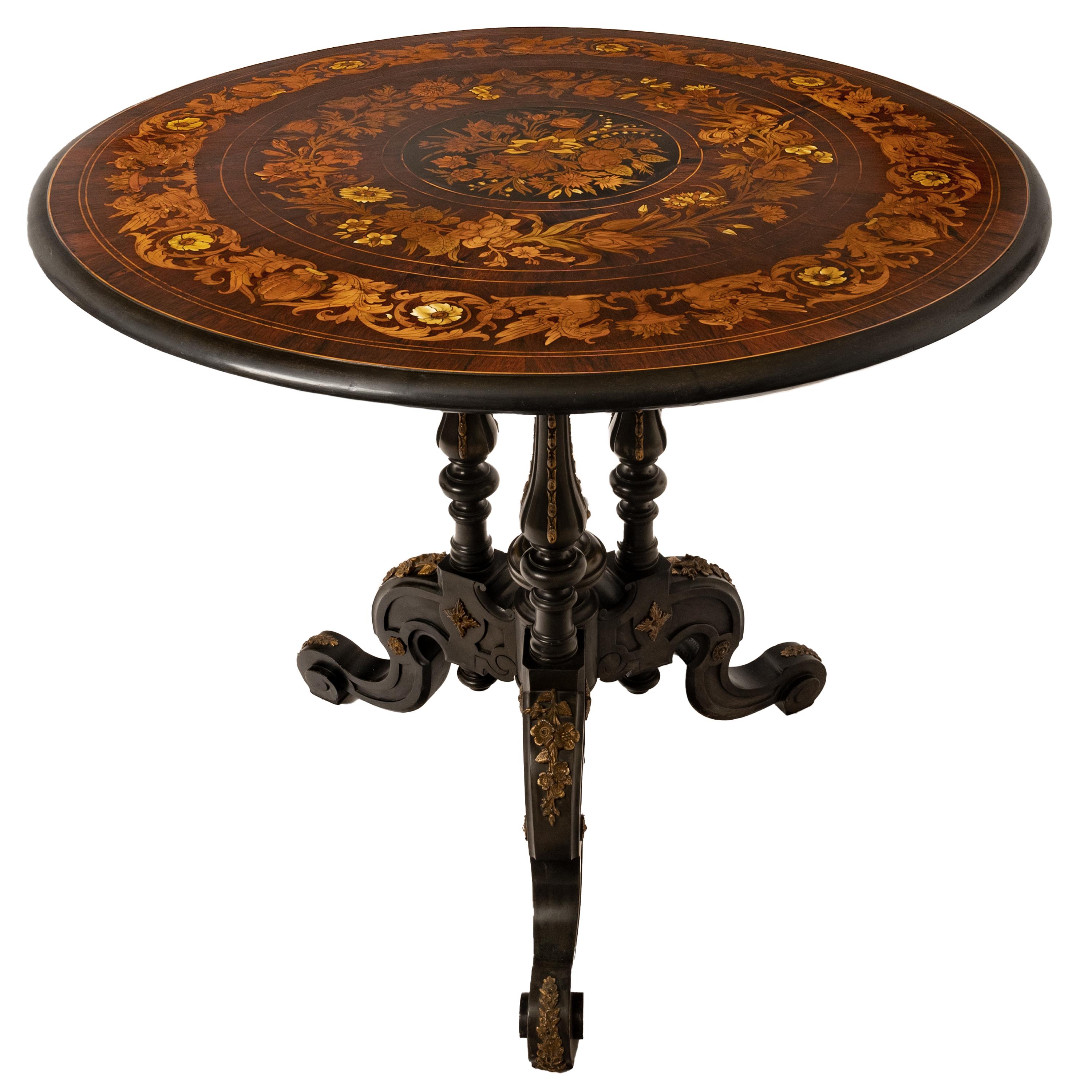 A very fine antique French Louis XV style, circular tilt-top marquetry pedestal tripod table, with gilt bronze ormolu mounts, attributed to Joseph Cremer circa 1870.
The round rosewood table top is sumptuously inlaid with many specimen woods, the