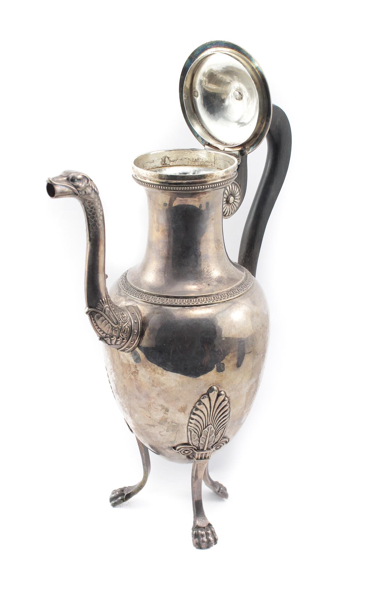 This is a stunning example of French Antique Sterling Silver in this Tall Tea Pot with a Black Finished Wooden Handle. The magnificent detail is of an Ostrich with a height of 10 3/4 inches and width of 7 1/4 inches. There is a Hallmark of a male