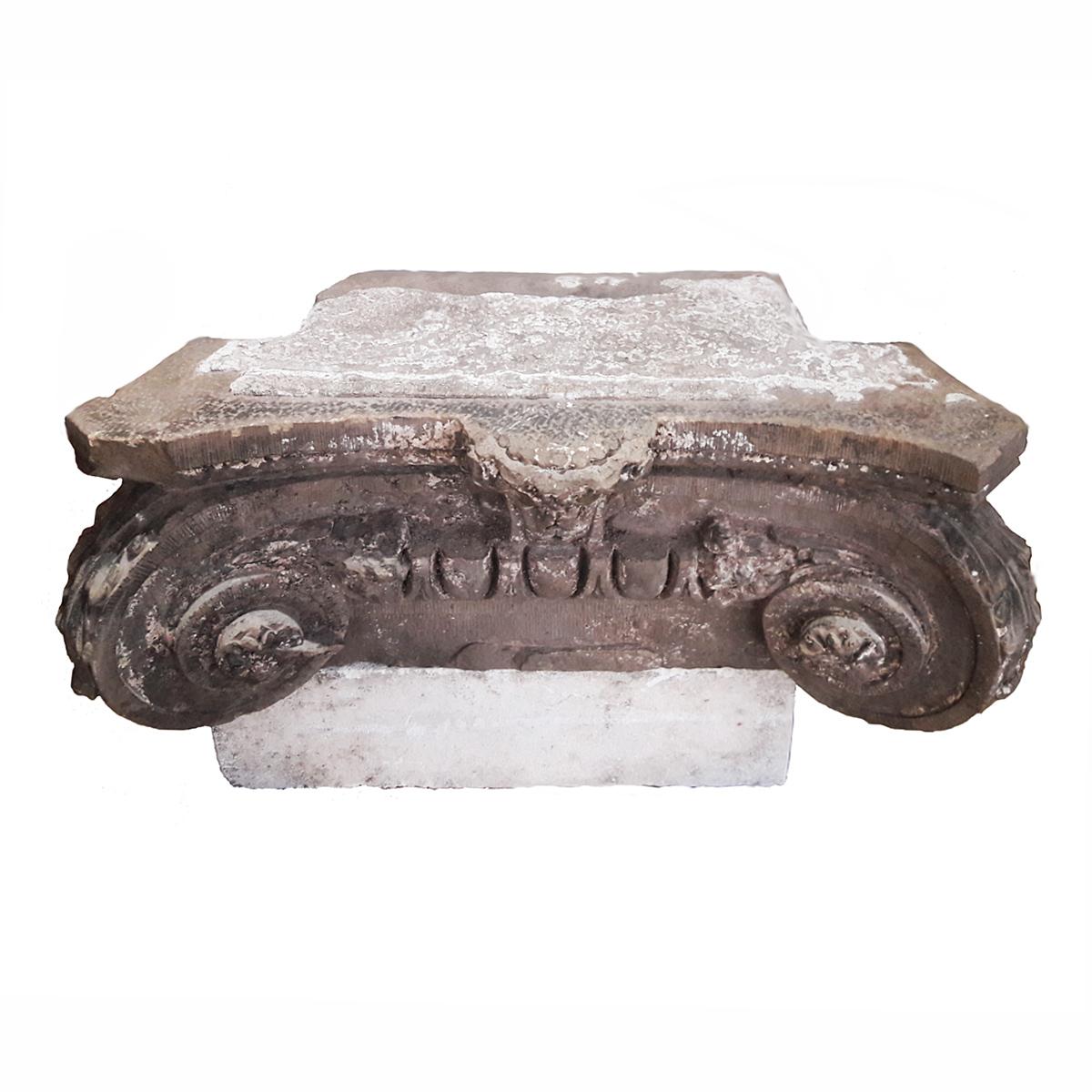 A carved stone capital from France, circa 1830. Ionian style. Comes with a white stone base. A singular piece that makes an eye-catching outside table or bench, or a superb accent for any indoor decor.

 35.5