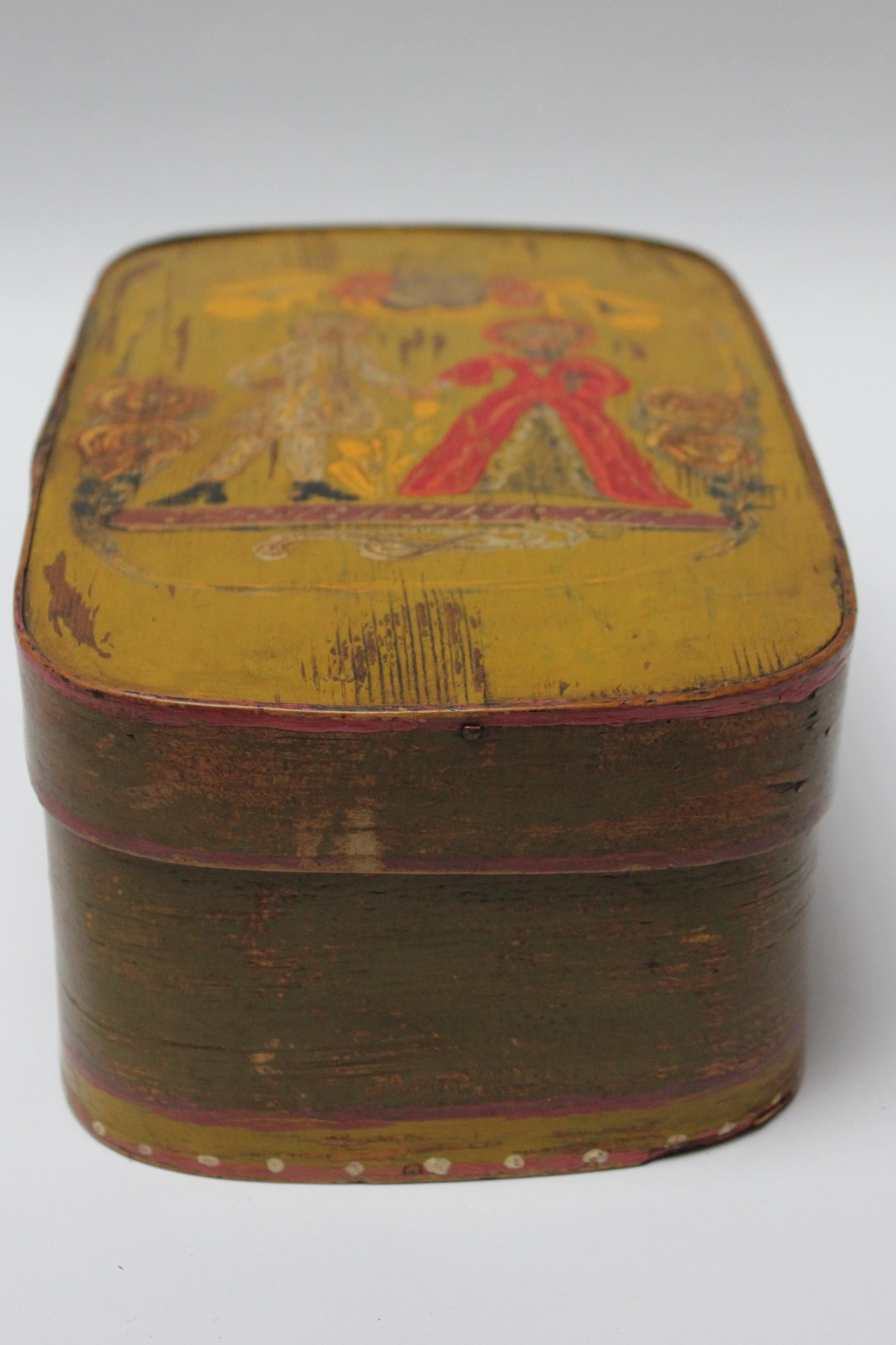 Ca. late 19th century French oak storage box with hand-painted 'clown' decoration to the top and a floral motif to the bottom component. Attractive color combinations - base coat is ochre with red, yellow, and coral, green, black and pink details.