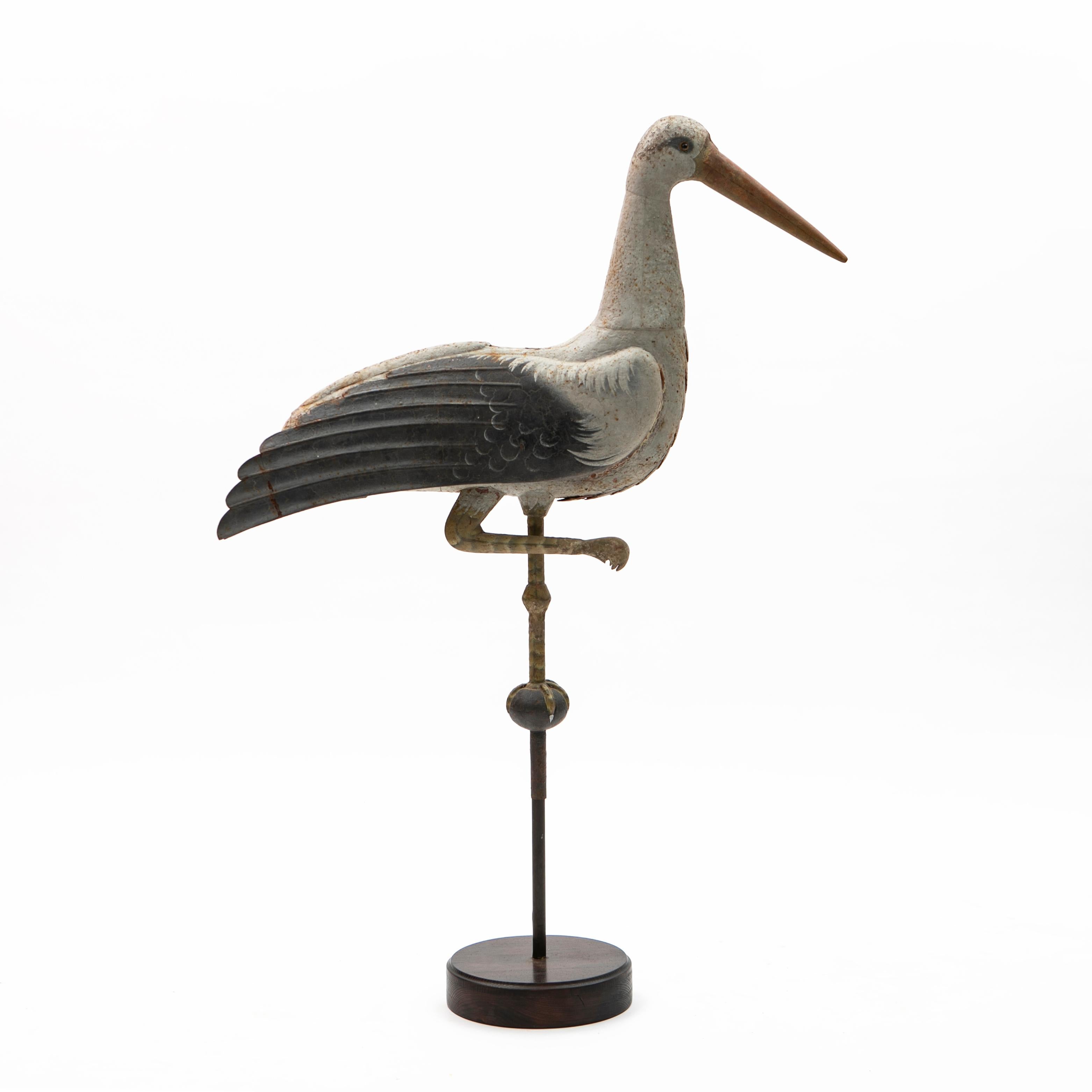 Wonderful and rare decorative weather vane in the form of a standing stork. 
Original hand painted metal. Height: 123 cm.

Presumably from a French Château, 1800s.

The weathervane has been later mounted onto a wooden base, but it is