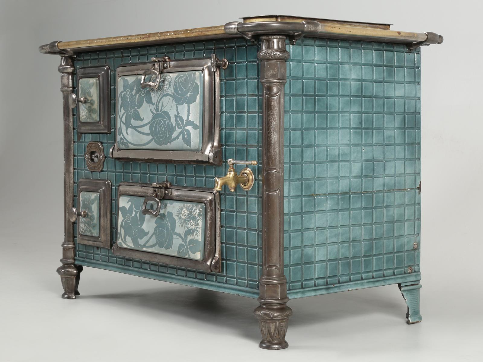 Antique French Stove that we thought would make for a perfect bar. Based on the tile design, we would estimate that it was built around the turn of the century (1888-1910). The hand painted tiles are clearly from the Art Nouveau period and please