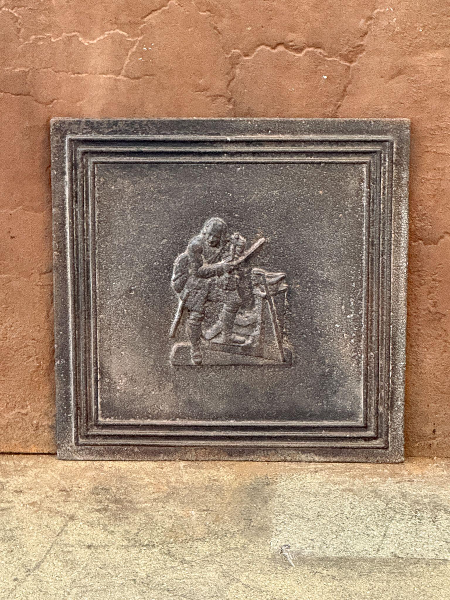 19th century French Victorian Period fireback with a street musician.

The fireback is made of cast iron and has a natural brown patina. Upon request, it can be made black/pewter at no extra cost. The fireback is in good condition and does not have