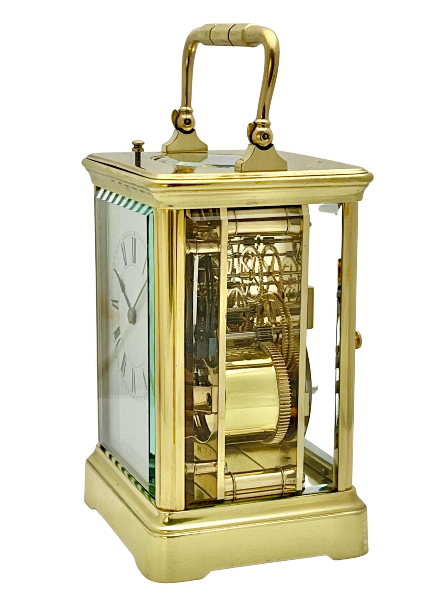 A wonderful antique French eight day striking and repeating carriage clock by Henri Jacot, Paris.

The case is polished brass with a fully glazed corniche style case with pivoted carrying handle and hour strike repeat button to the top. A white