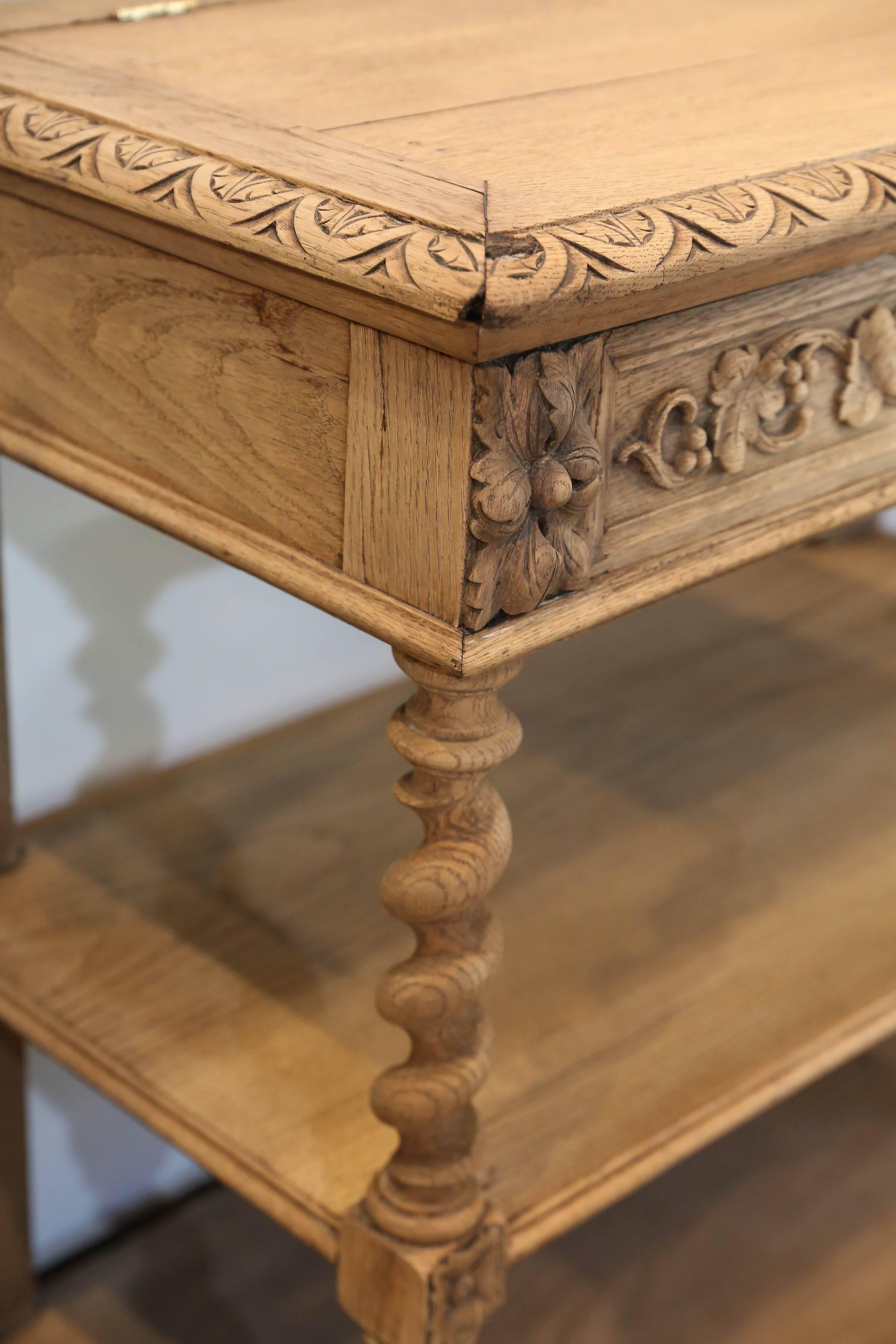This is an exceptionally beautiful dessert table in hand-carved oak with wonderful spiral legs and a wine grape and leaf motif. The top is hinged and lifts into place with two carved supports. The marble top underneath is a wonderful charcoal gray