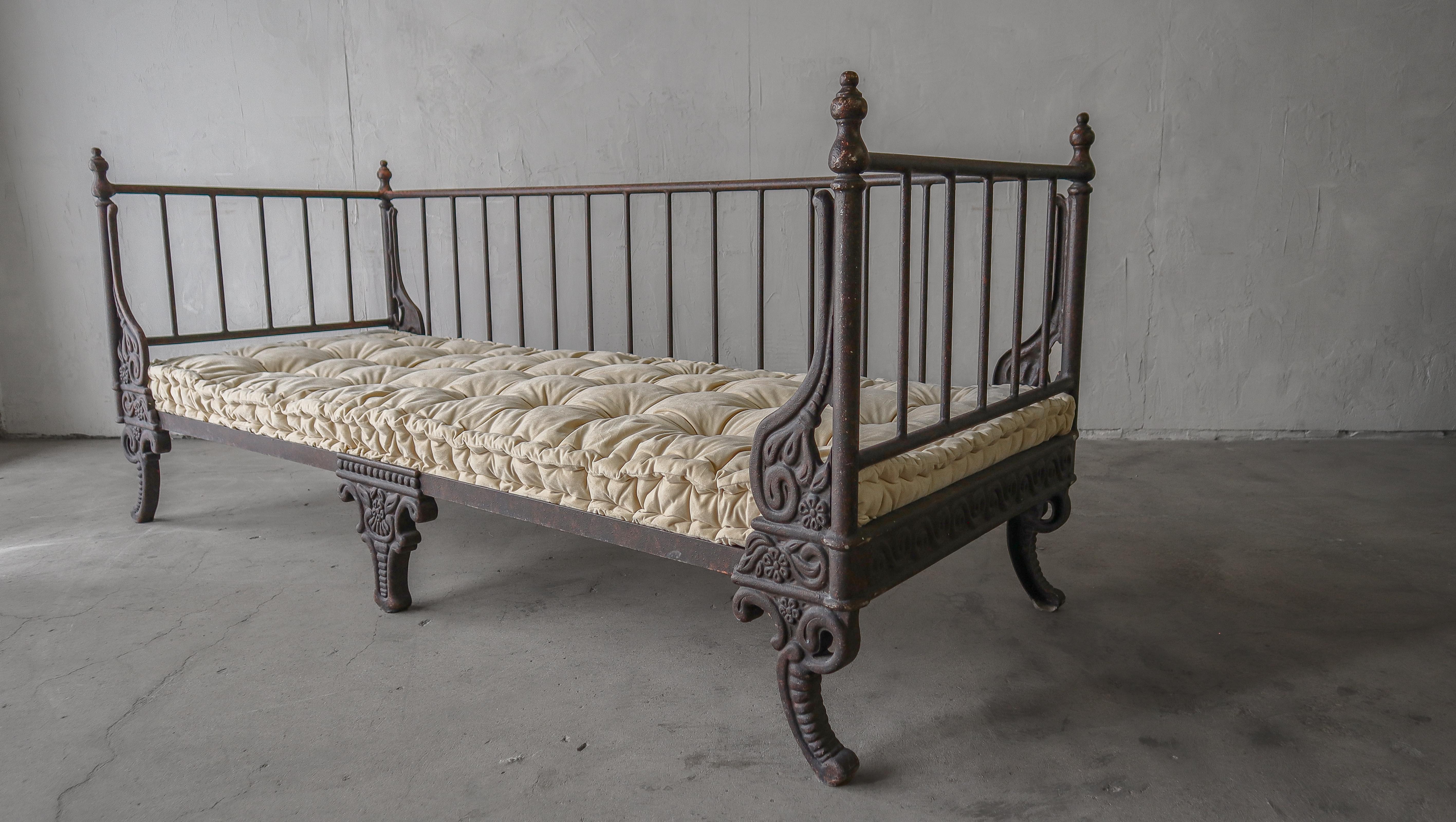 Add some european styled, rustic charm to your space with this hand patinated, cast metal daybed.  The cushion is a soft cream velvet, with thick welt and big button details that add additional visual interest, while softening the piece to the