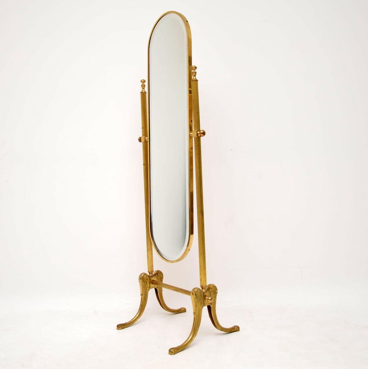 Antique French style brass cheval mirror in good original condition. This piece has a full length bevelled brass framed mirror which sits on a brass framework. The mirror can be adjusted to any angle with the help of brass side handles. The brass