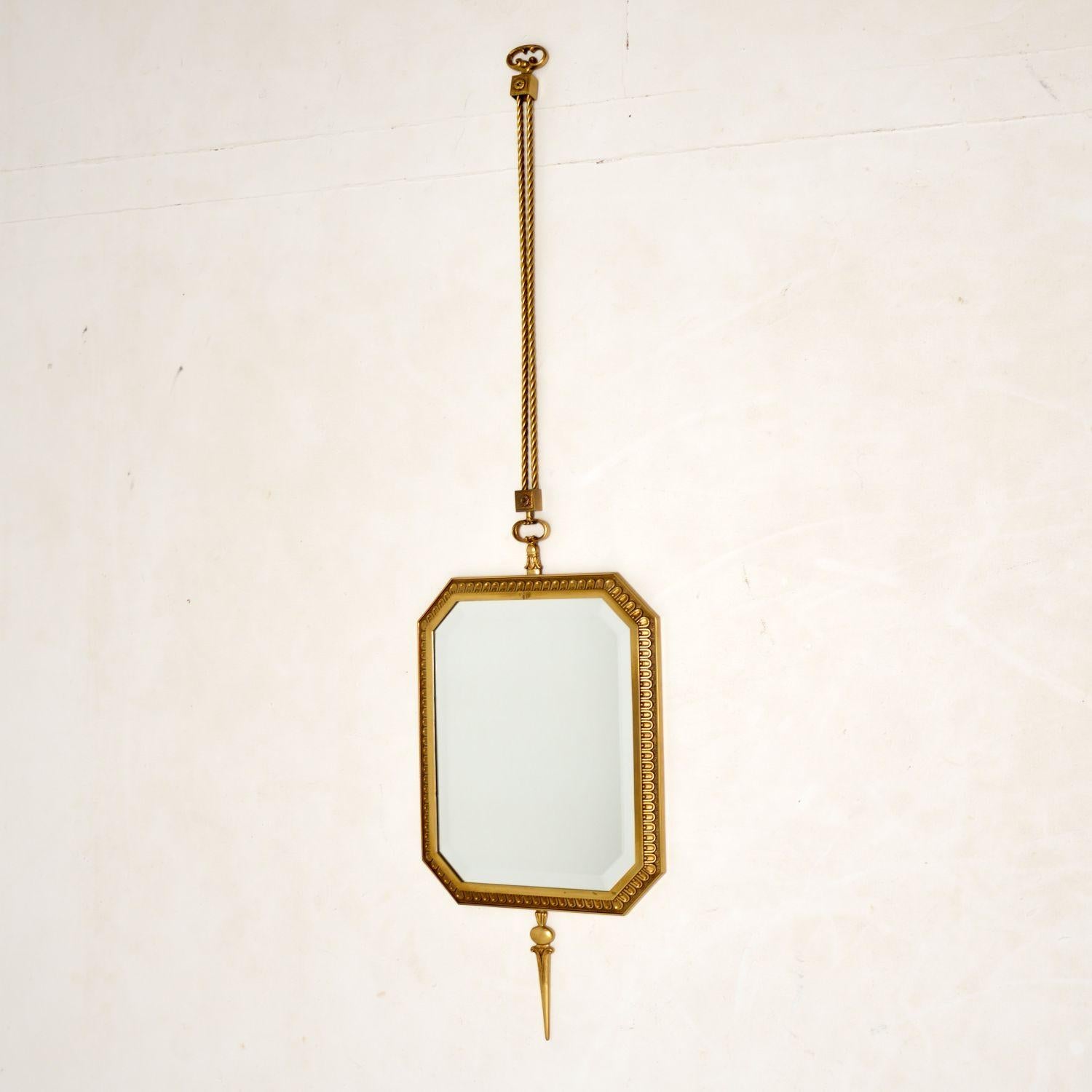 A stunning vintage pendant mirror in solid brass. This is in the antique French style & I would date it from the 1950’s period.

It is of wonderful quality, the brass frame has beautiful detail and hangs by solid brass double rope twists. The