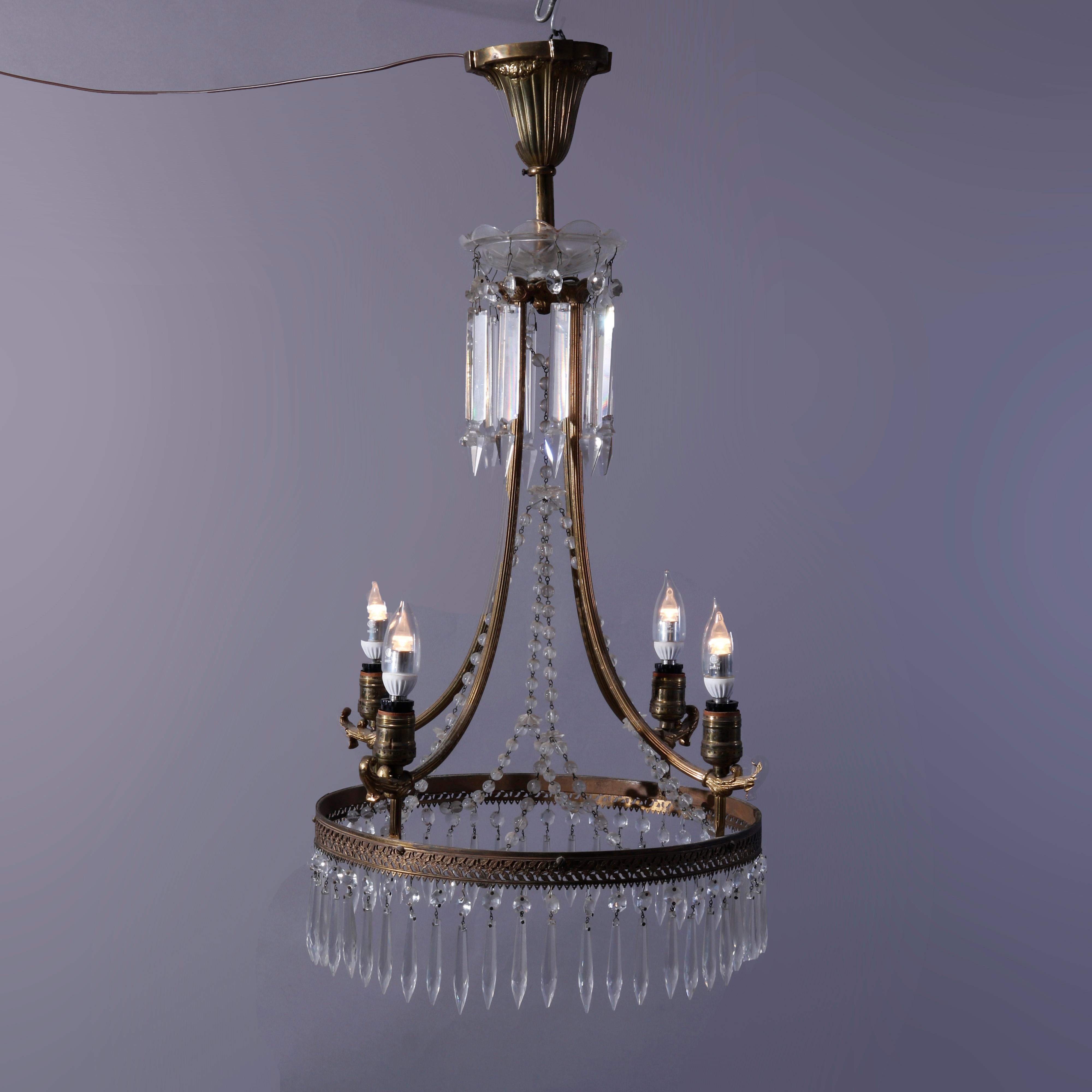 An antique French style chandelier offers bronzed metal frame with four scroll form arms terminating in a drop pierced crown having four lights, cut drop and draping strung crystal highlights throughout, classic Roaring '20's, c1920

Measures -