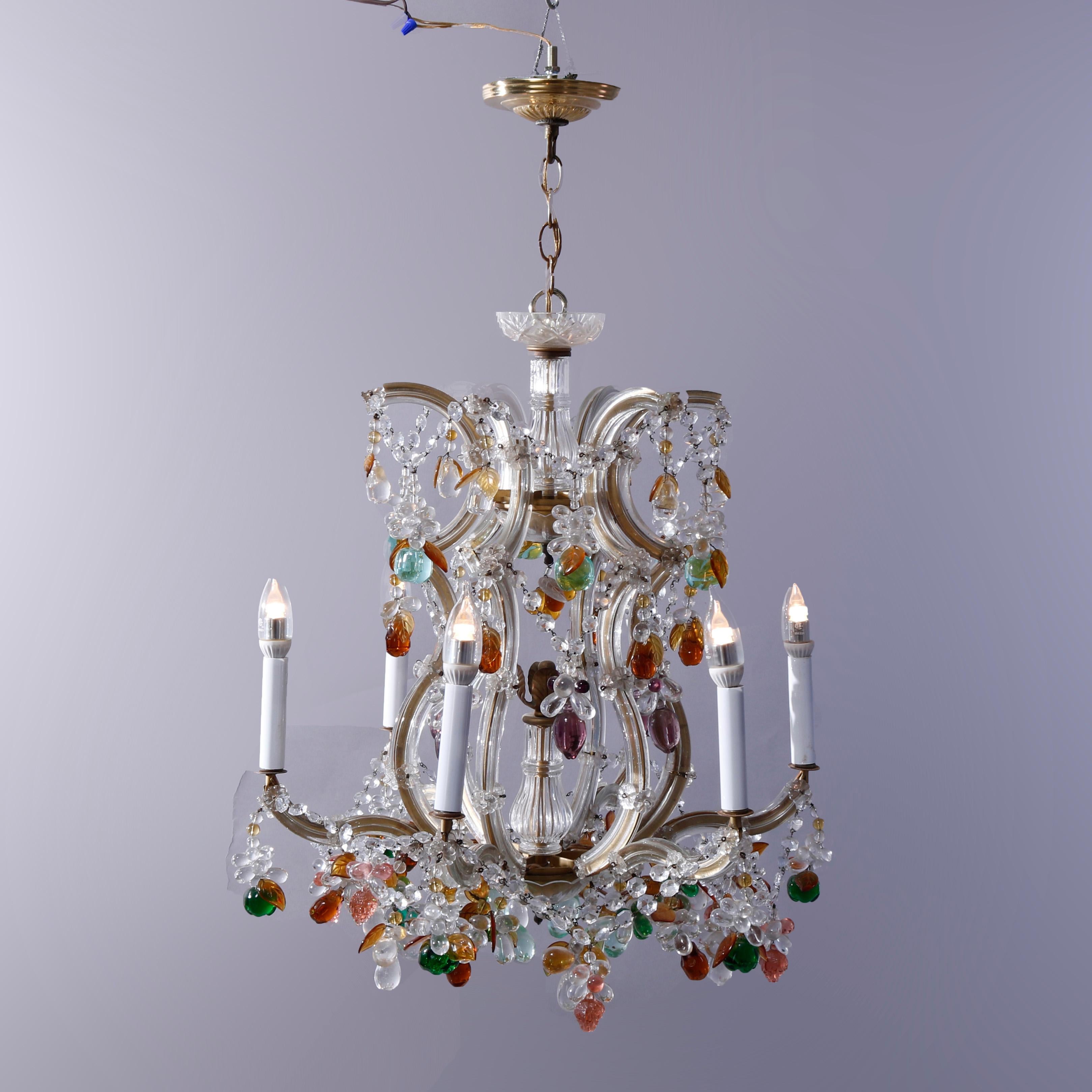 An antique French style chandelier offers brass frame with scroll form arms terminating in candle lights and having strung and drop polychrome (multi-color) crystals throughout, c1940

Measures - 36''h x 18''w x 18''d.

Catalogue Note: Ask about