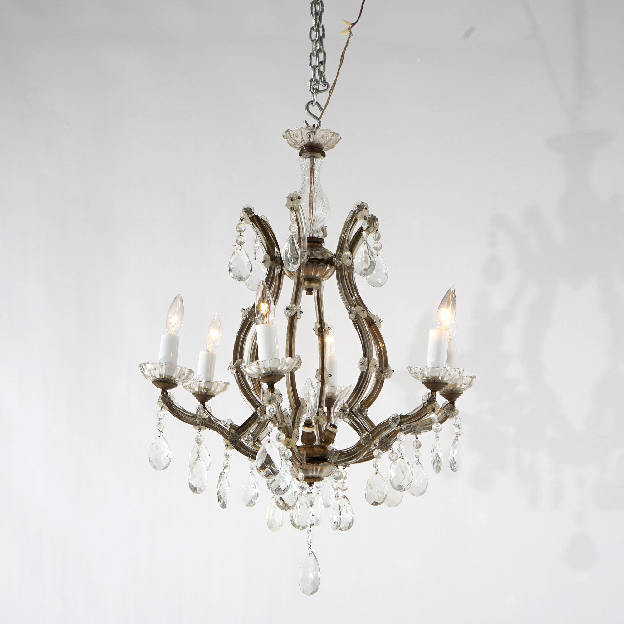 An antique French style chandelier offers gilt metal scroll form frame with arms terminating in candle lights and having crystal highlights throughout, c1940

Measures - 27