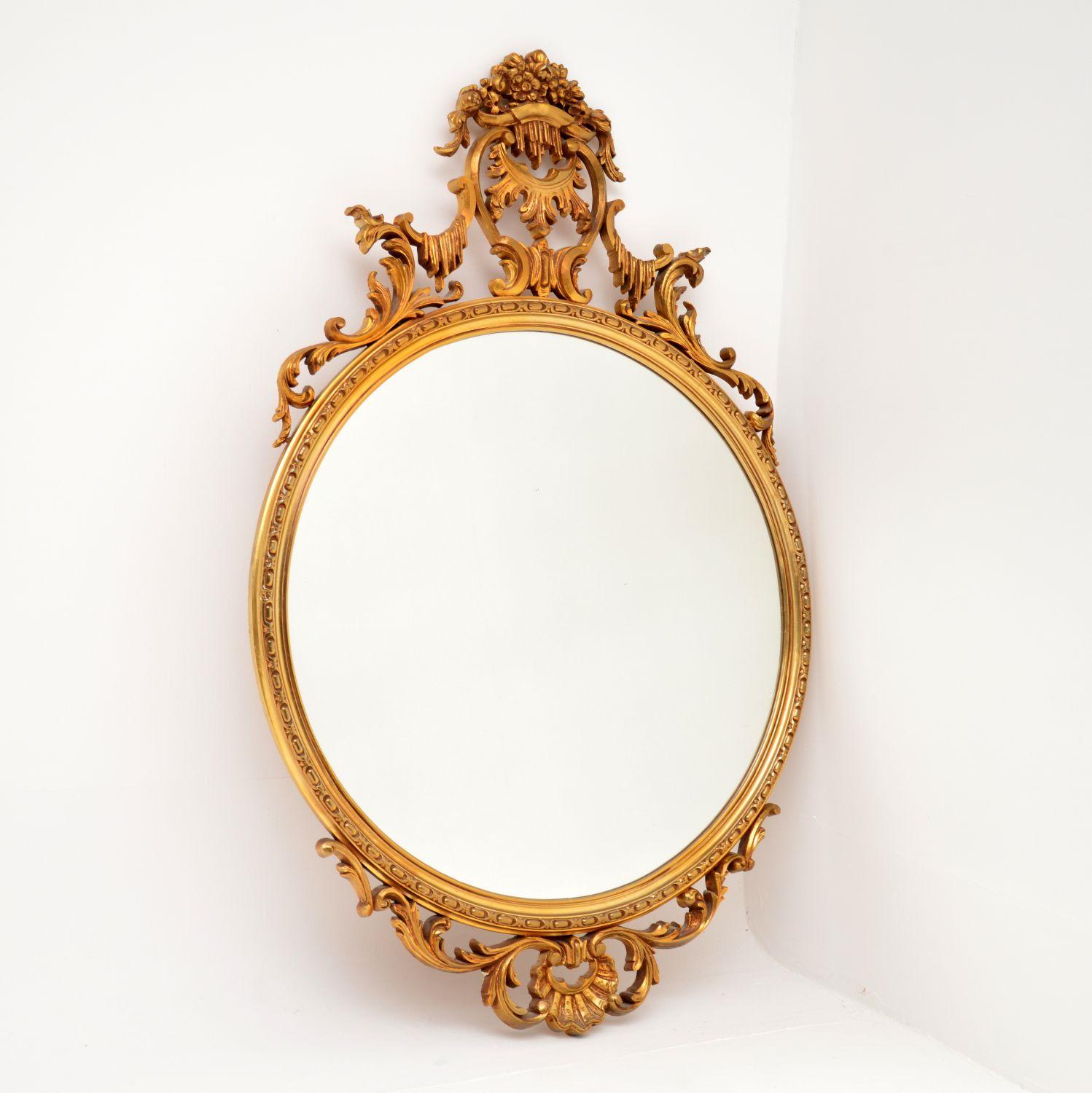 A beautiful and very impressive antique French style mirror. This was actually made in England, it dates from around the 1950-60’s.

The gilt frame has absolutely gorgeous and intricate motifs throughout. It is of lovely quality and is made from a