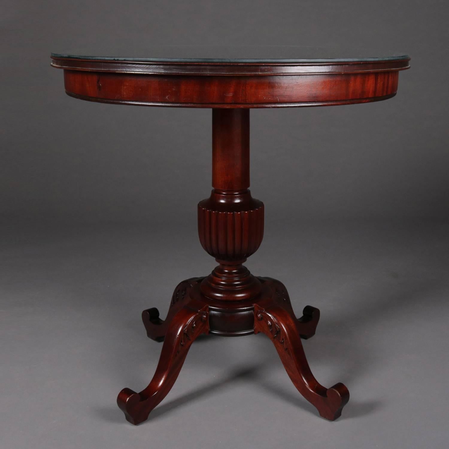 Antique French style Horner Bros. round center table features flame mahogany construction with urn form pedestal raised on three foliate carved scroll form legs, protective glass top, circa 1900


Measures: 31