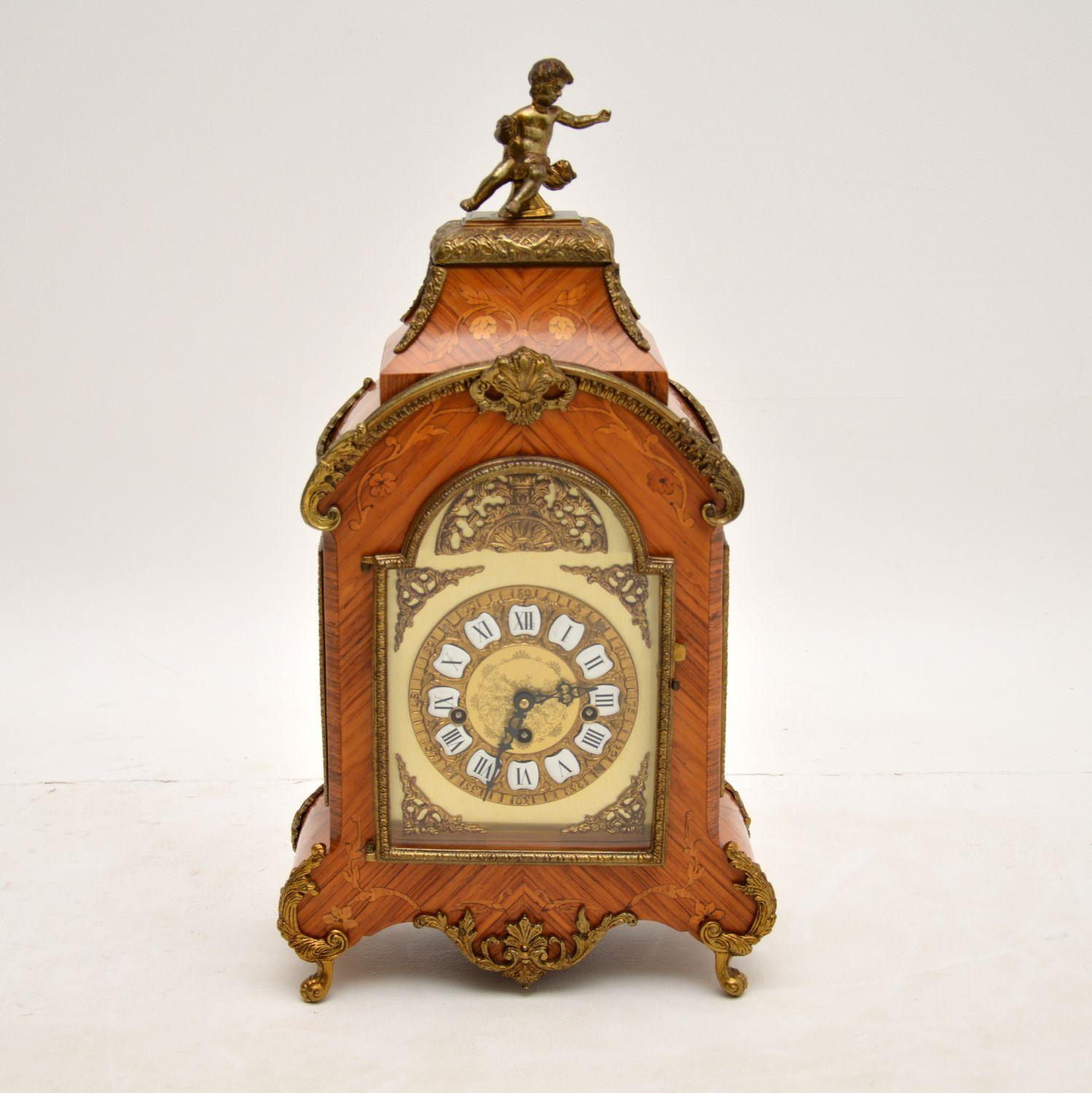 A stunning mantel clock in the classic antique French style. This was made in France & it dates from around the 1950’s period.

The quality is fabulous, it is beautifully constructed from kingwood & other various inlaid woods. This clock has