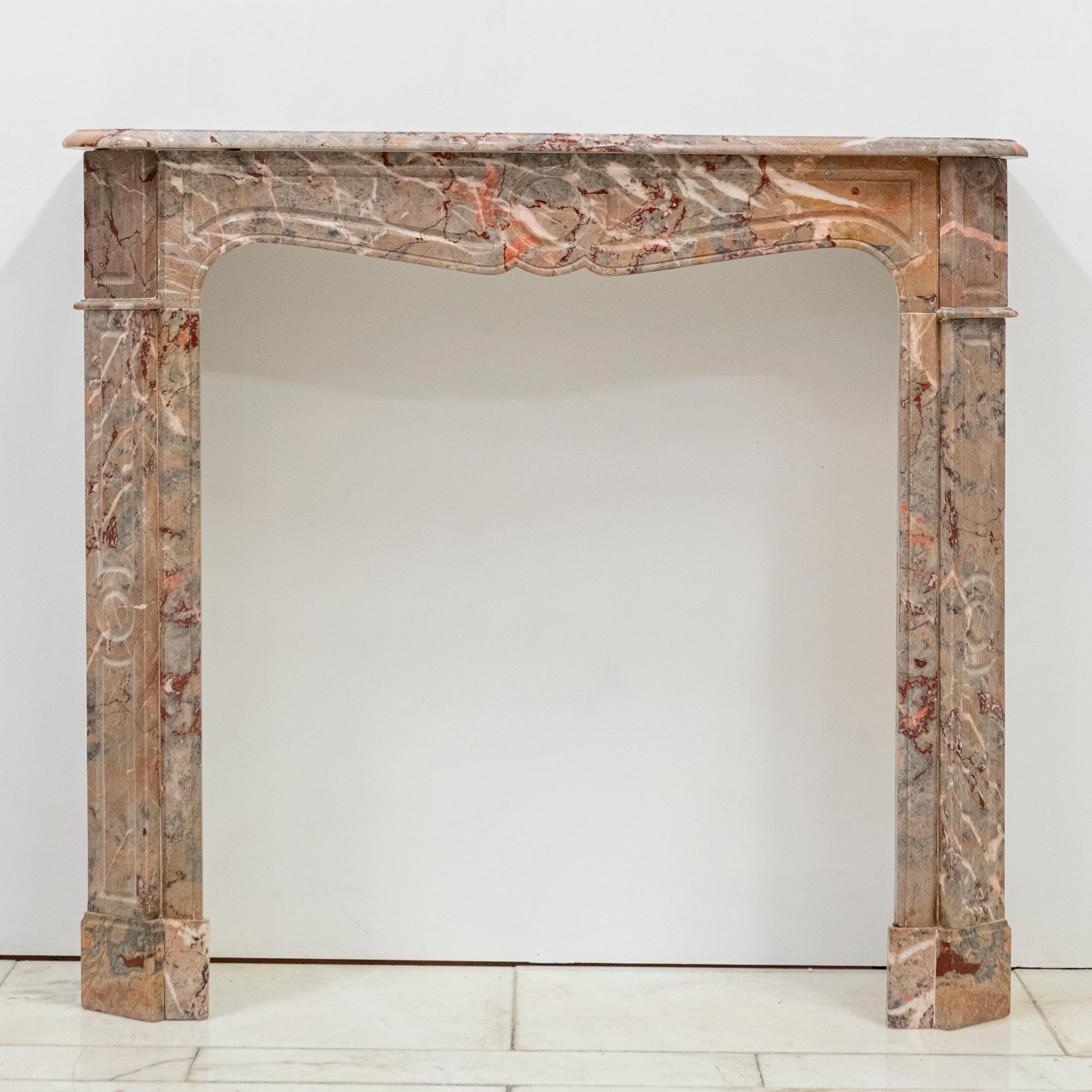 This antique chimneypiece has been crafted from striking ashburton marble in the very popular and elegant French, pompadour design.

The fireplace surround is in the distinctive French Louis XV style, with a serpentine shelf,  shaped opening and