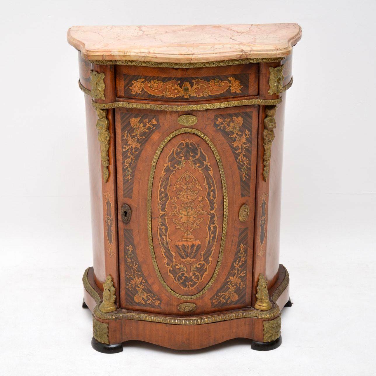 Antique French style marble-top cabinet of very small proportions and in good condition. It has a serpentine shaped front, a single drawer & a single cupboard with one shelf inside. This cabinet was probably made about 40 or 50 years ago. There is a