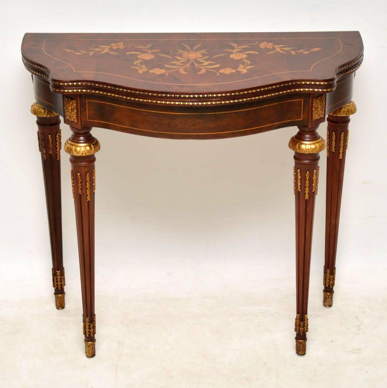 Antique French style walnut card table with a serpentine shaped front and lovely decoration. It dates from circa 1950s period and is in good condition. The top is burr walnut and has a very detailed and colorful floral marquetry made up from many