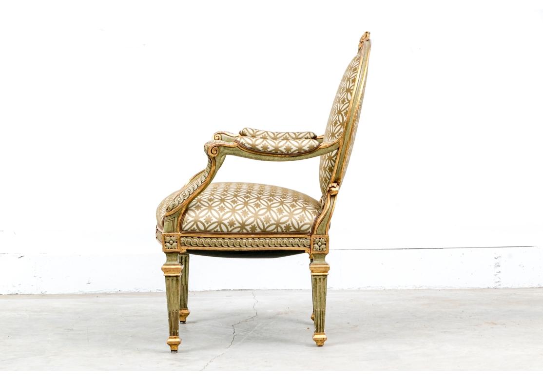 A fine and decorative early 20th  century  French fauteuil with a fine green painted and gilt carved frame with guilloche bands on the oval back, arms and seat rail and having a carved bow and ribbon crest and olive leaves on the seat rail. Raised