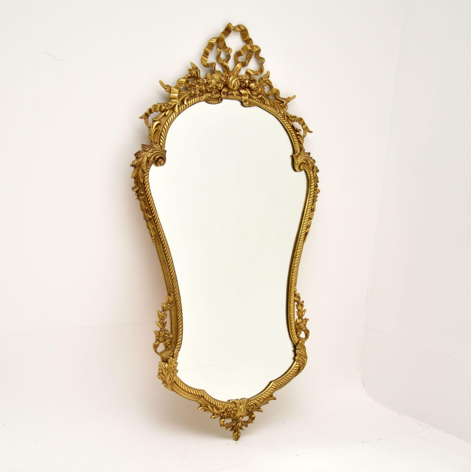 A stunning solid brass mirror in the antique French style, this dates from around the 1950-60’s.

It is a great size and is of amazing quality. The details are beautiful and intricate throughout, with floral and ribbon motifs. It is wonderfully