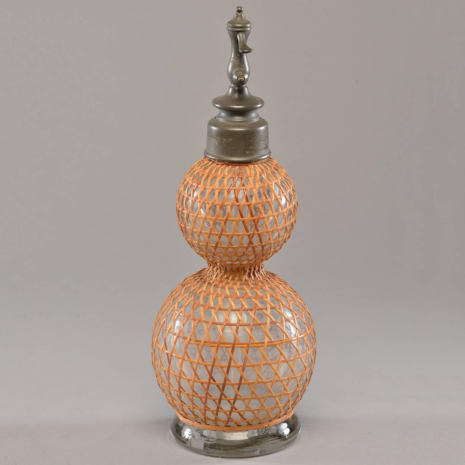 French double globe syphon bottle with pewter spout features hand woven rattan cover in classic caning pattern. Excellent antique condition, circa 1910.
