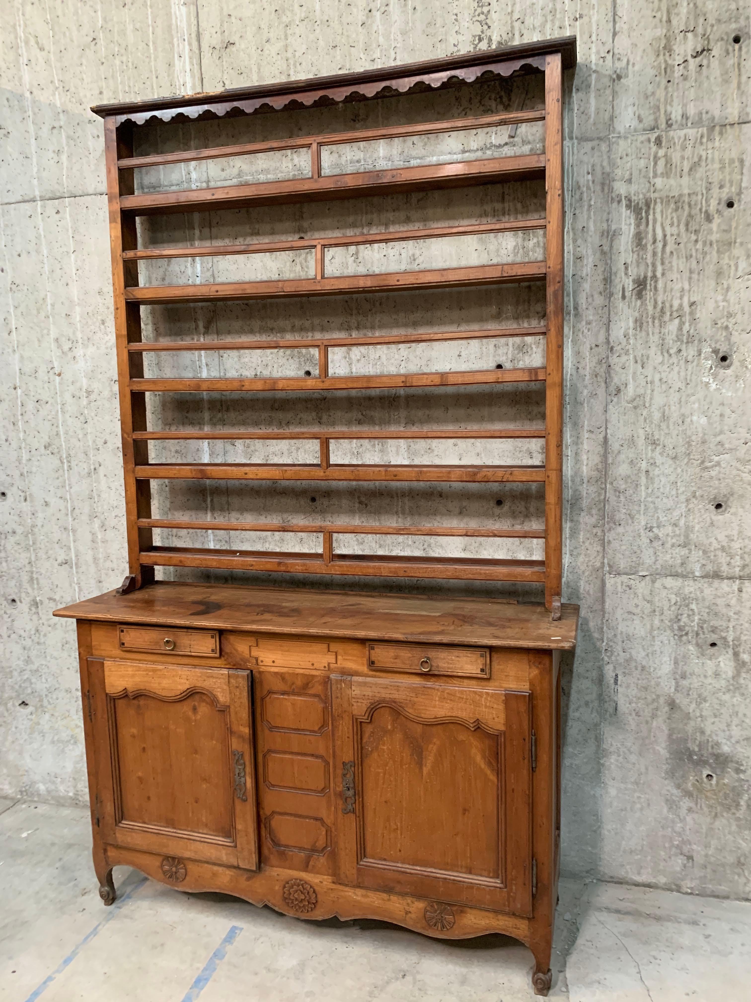 French Provincial Louis XV Cherrywood buffet features 2 drawers, 2 doors, rising on cabriole legs, ending in whorl feet. Carved embellishments on the scalloped apron add charm. The buffet dish display features carved embellishments on the scalloped