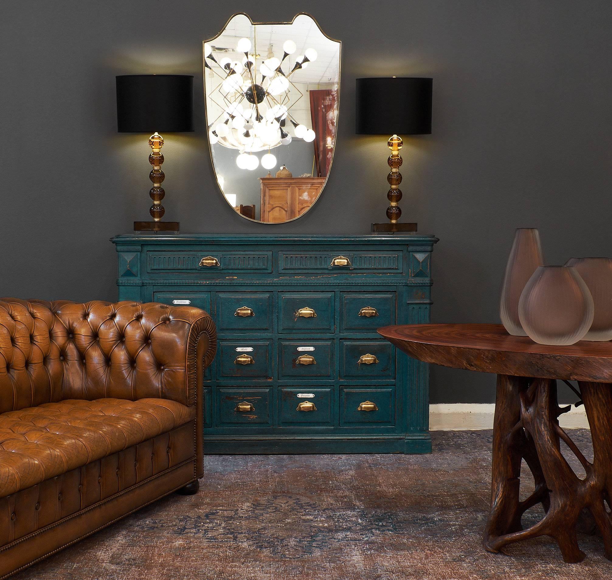 All original French antique teal apothecary cabinet with 14 dovetailed drawers, porcelain tags, and solid brass handles. There is beautiful fluting details throughout, and features a great original teal blue color.