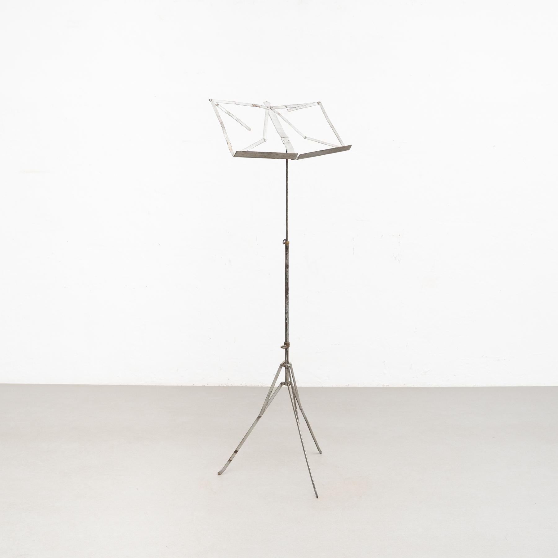Antique French telescopic metal music stand.    Made by unknown manufacturer, France, circa 1940.    In original condition, with minor wear consistent with age and use, preserving a beautiful patina.     Materials:  Metal.   