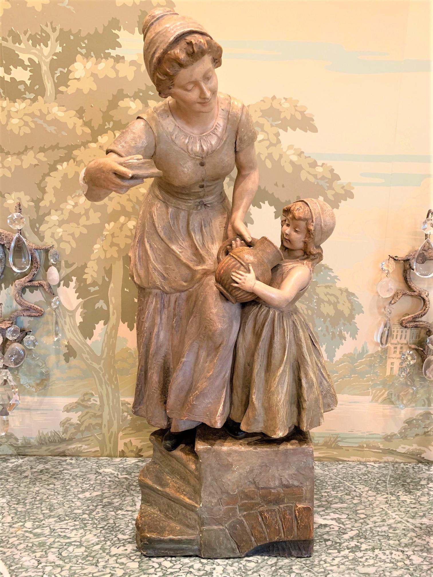 Amazingly life-like antique French terracotta figurative sculpture depicting a mother and child with water vessel. Each dressed in period costume. Superbly hand painted in a blend of colors to emphasis detail and motion. Impressed, stamped, and