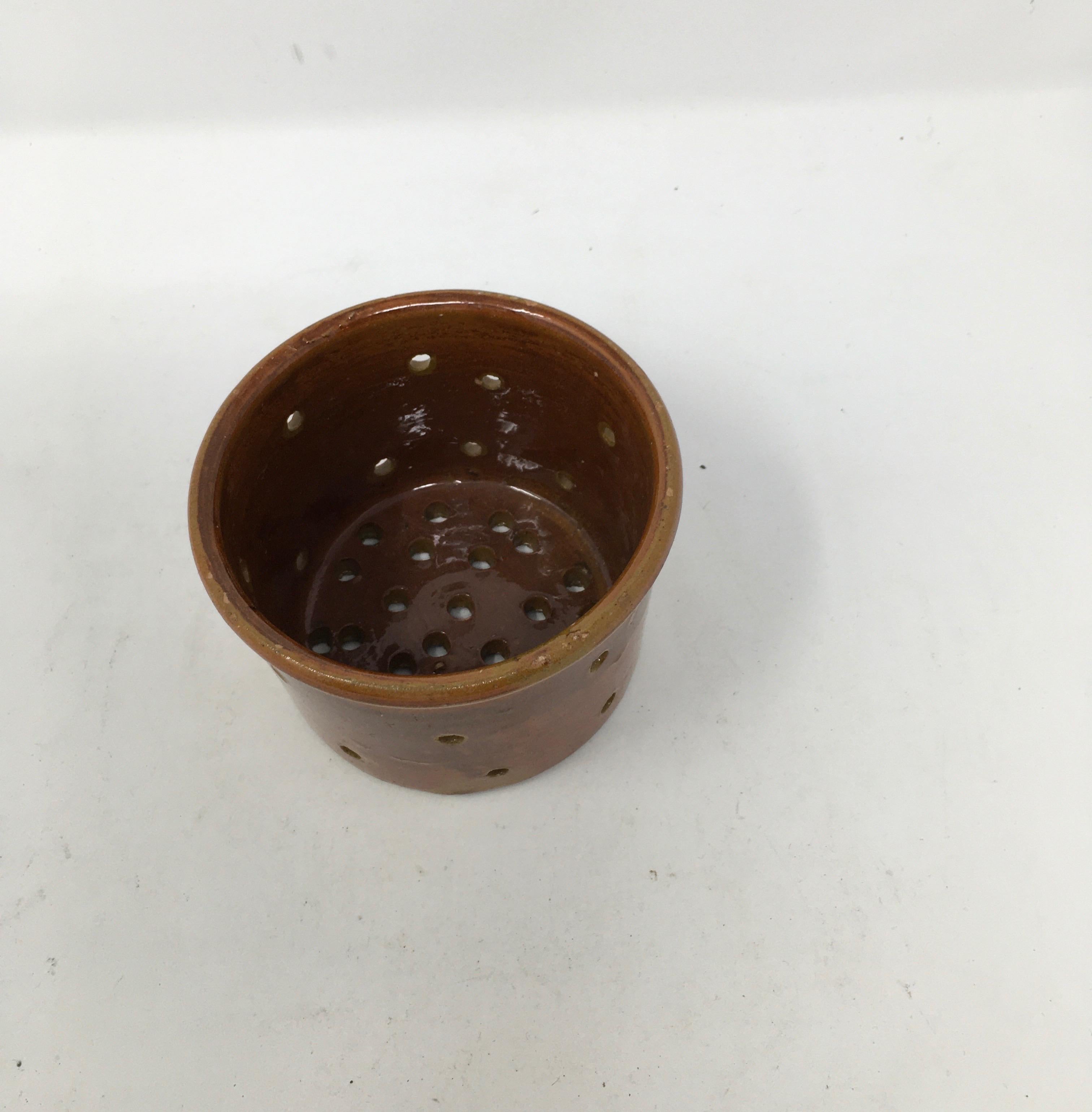 This antique French terracotta glazed cheese mould or cheese strainer is full of character. It is in excellent condition, no chips or cracks. Lovely as decoration, for flowers or candles on a summer evenings.