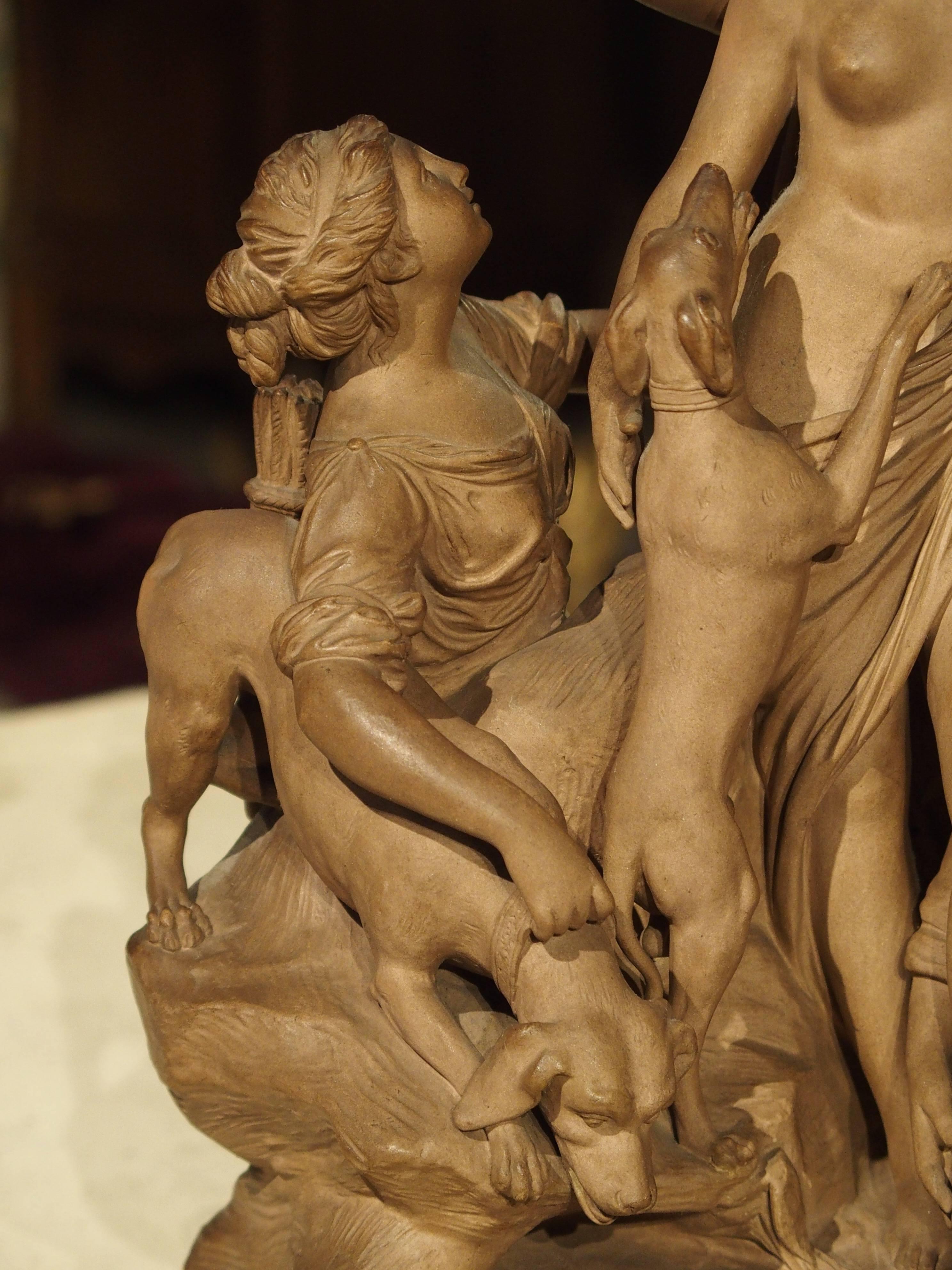 This magnificent terracotta statuary depicts Diana as the focal point of the group. Two playful dogs want to be a part of the entire process with one jumping up on her body! Three women are attending her, one washing her foot, another is on the