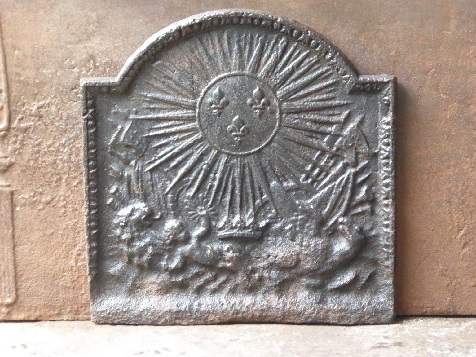 18th-19th century French neoclassical fireback. The sun is symbol for the French King Louis XIV, called the Sun King.

The fireback is made of cast iron and has a natural brown patina. Upon request it can be made black / pewter. The fireback is in