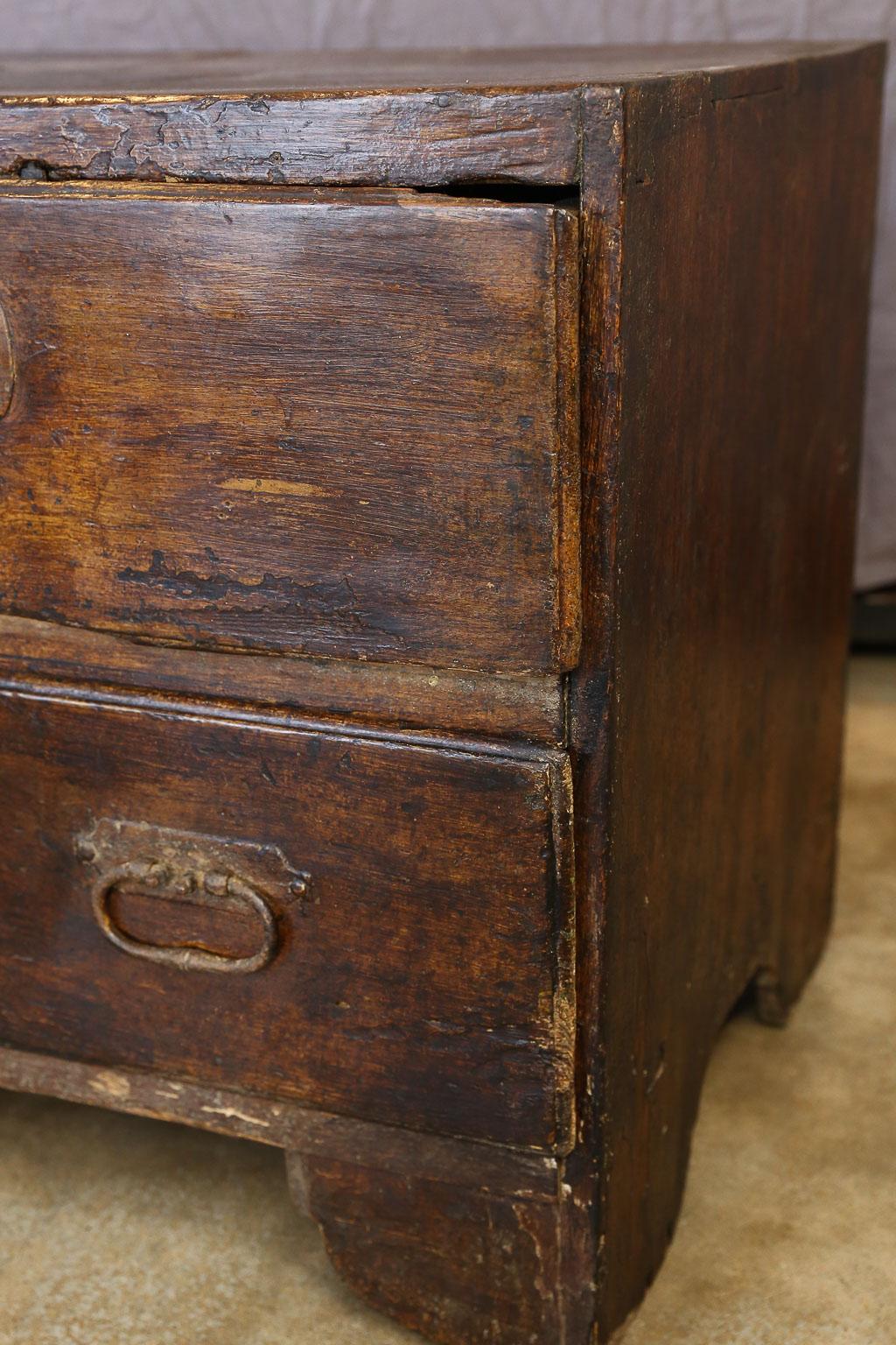 This is a handmade French three-drawer chest, circa 1820. The piece features two drawers over one large drawer with hand forged iron pulls and two keys. The chest is strong and solid with a lovely hand waxed patina.