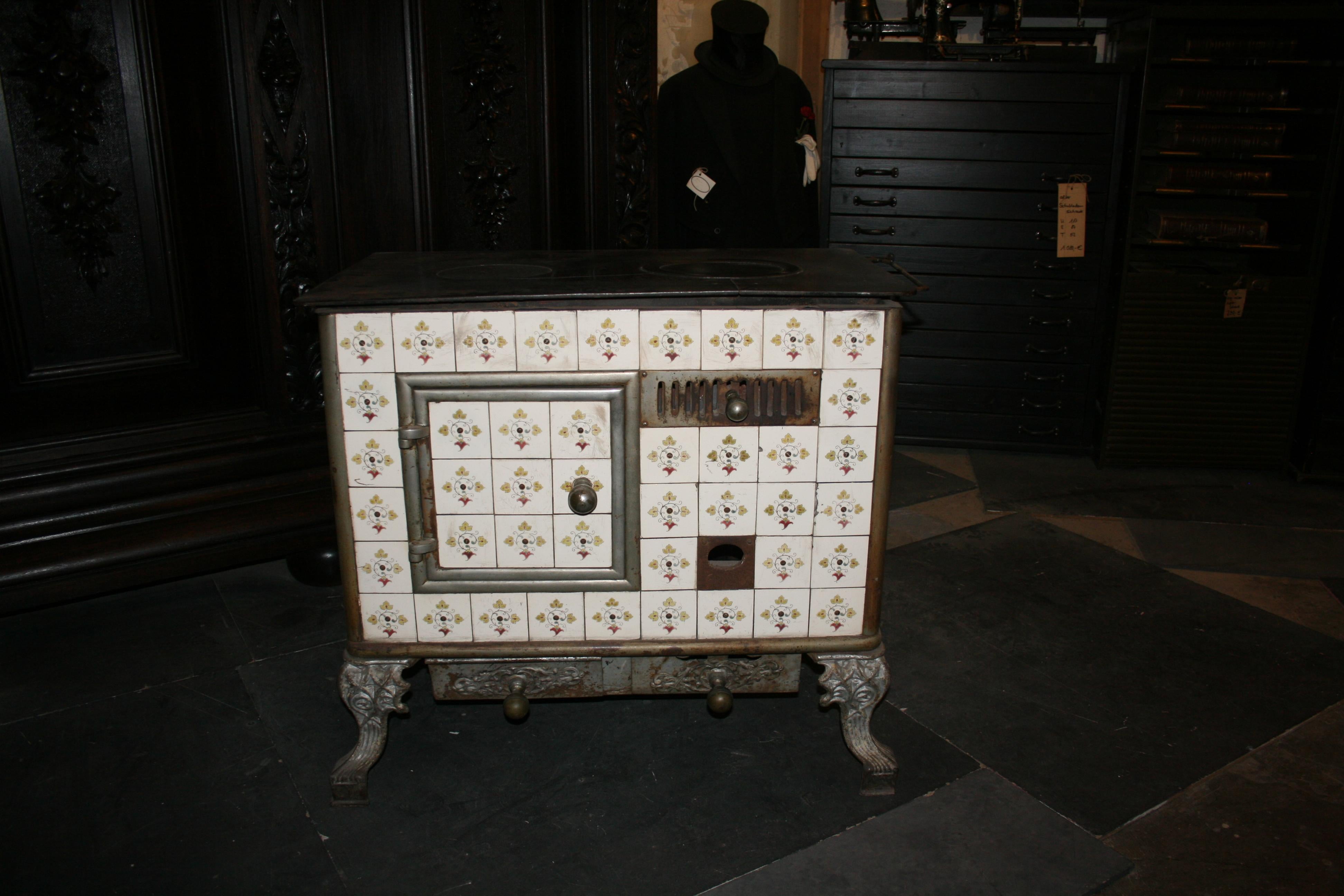 Original antique cast-iron French tiled stove from circa 1890.

Dimensions: 80 cm high, 85 cm wide, 50 cm deep.