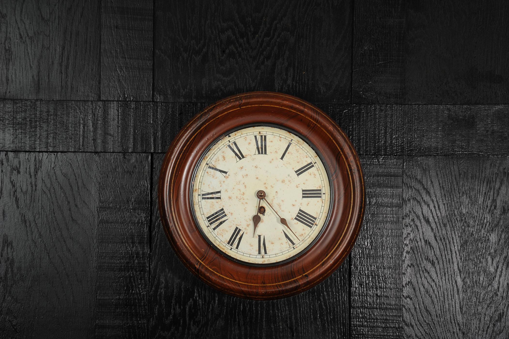 Evoking the quiet poetry of abandonment, this early 20th century wall clock blends timeworn elegance with raw industrial character. Made from painted steel to mimic wood grain, the tole frame has aged beautifully — its surface weathered and softened