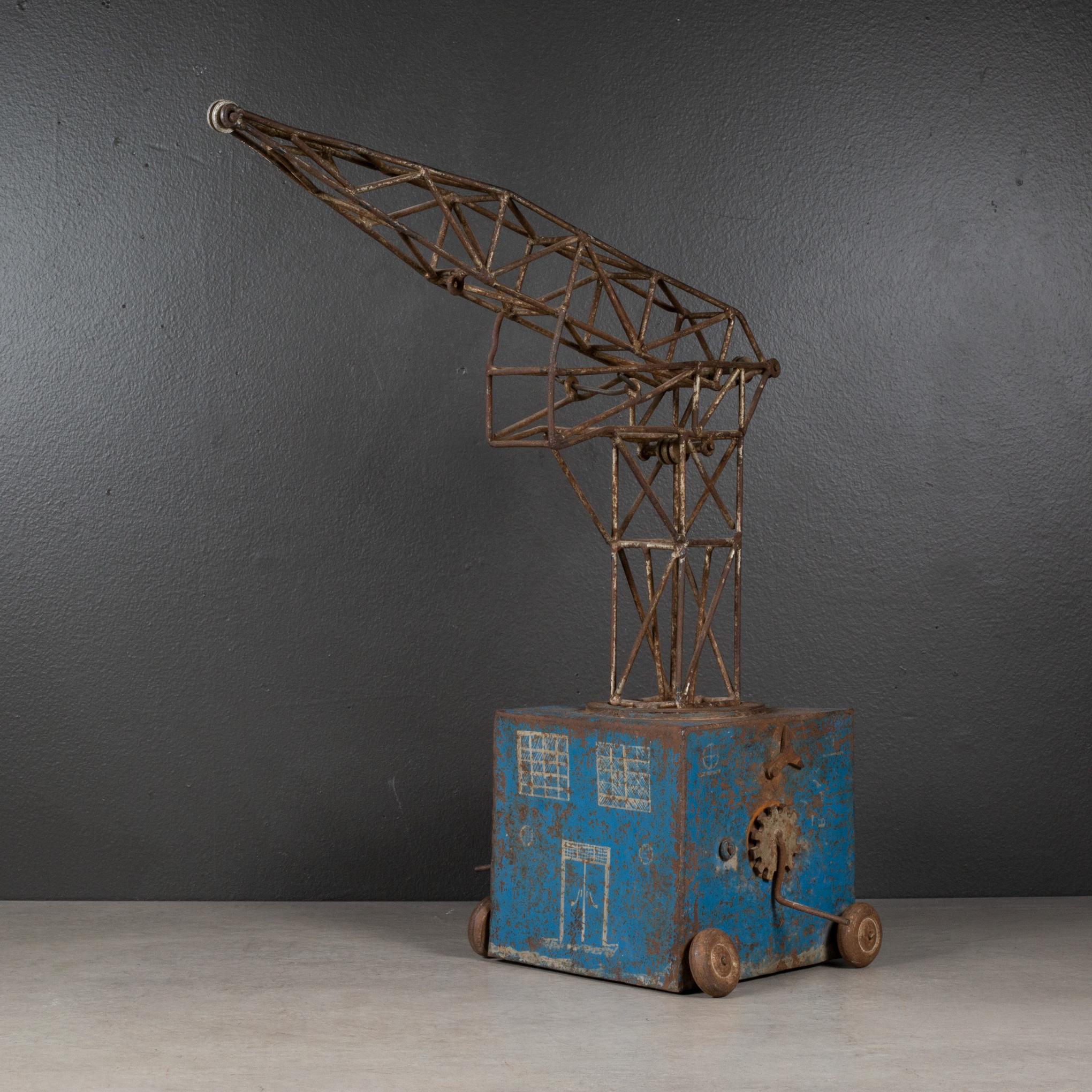 ABOUT

An antique French toy crane with two crank handles and brakes on each side and metal wheels. Graphics are on three sides include windows, a clock and 