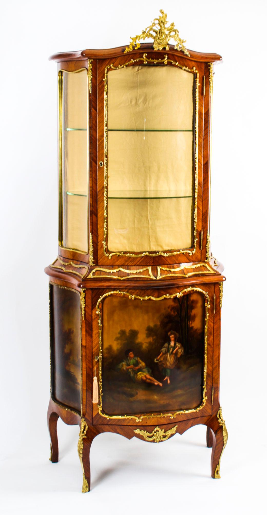 This is a stunning antique French Vernis Martin vitrine, in the Louis XV transitional manner, circa 1880 in date, with exquisite hand painted decoration and exquisite ormolu mounts.

The top has serpentine glass sides with a central bow glazed