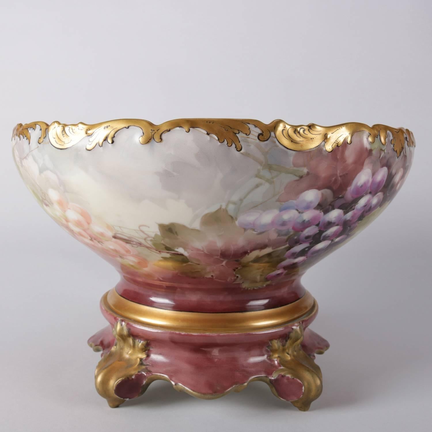 Antique French Limoges porcelain punch bowl by Tress manes Vogt T&V features grape and leaf all over decoration with heavy gilt accents and is seated on scroll for gilt feet, inside also with grape and leaf, maker stamp on base, 19th
