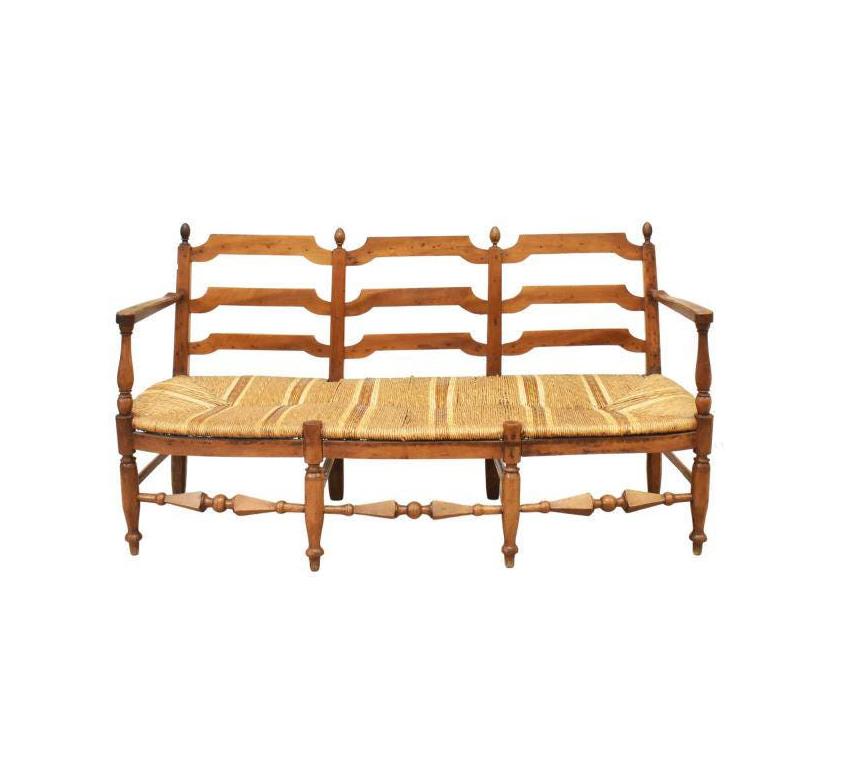 French Provincial triple chair back settee, late 19th/ early 20th c. This settee features a walnut frame with turned finials, ladder back, woven rush seat, rising on turned legs joined by stretchers, ending in blunt arrow feet.

Dimensions
approx