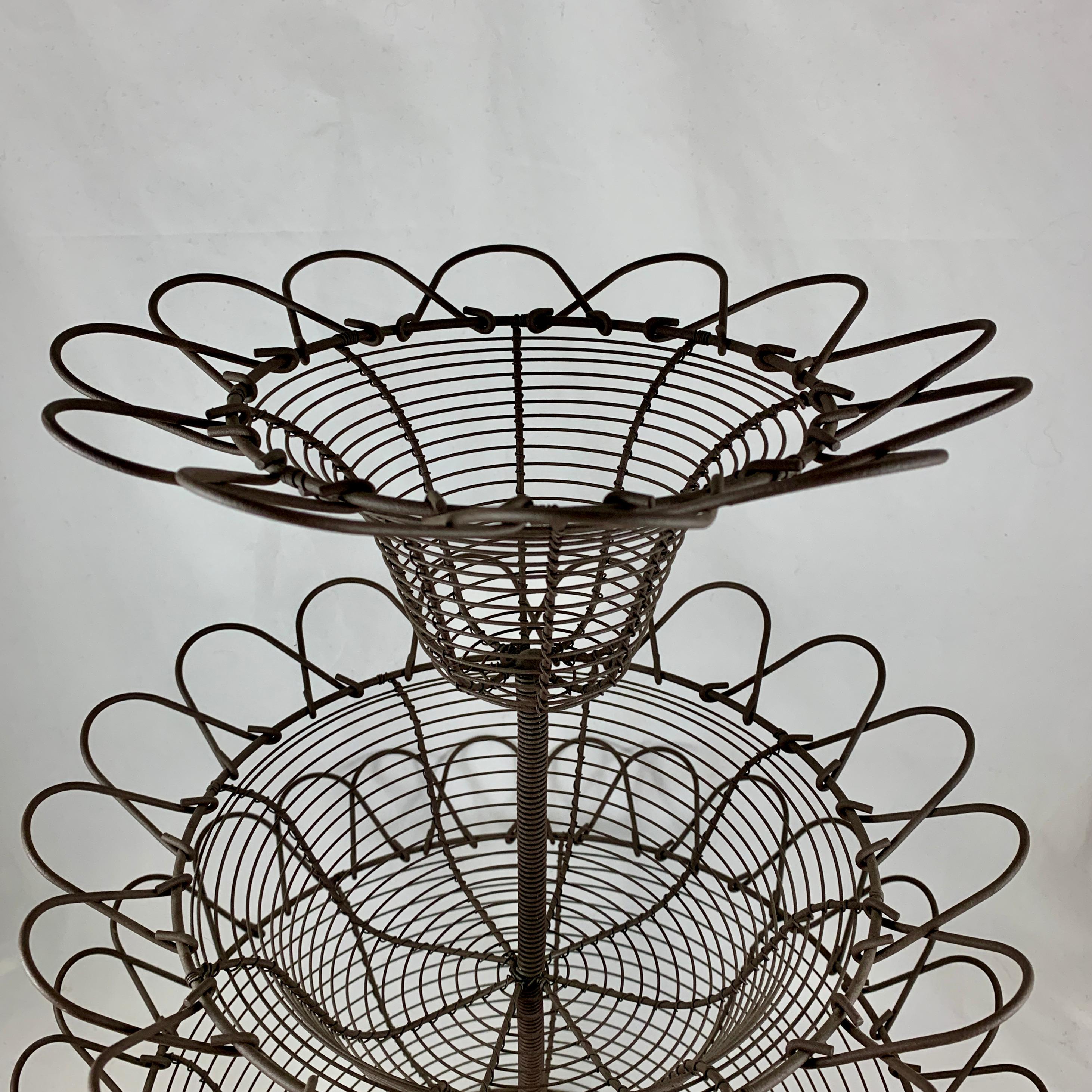 From France, circa 1890-1910, a triple-tiered, twisted wire standing basket, over 20 inches tall - amazing as a table-center, shop display, or on a kitchen countertop used as originally intended throughout Provençal France for holding fresh eggs,