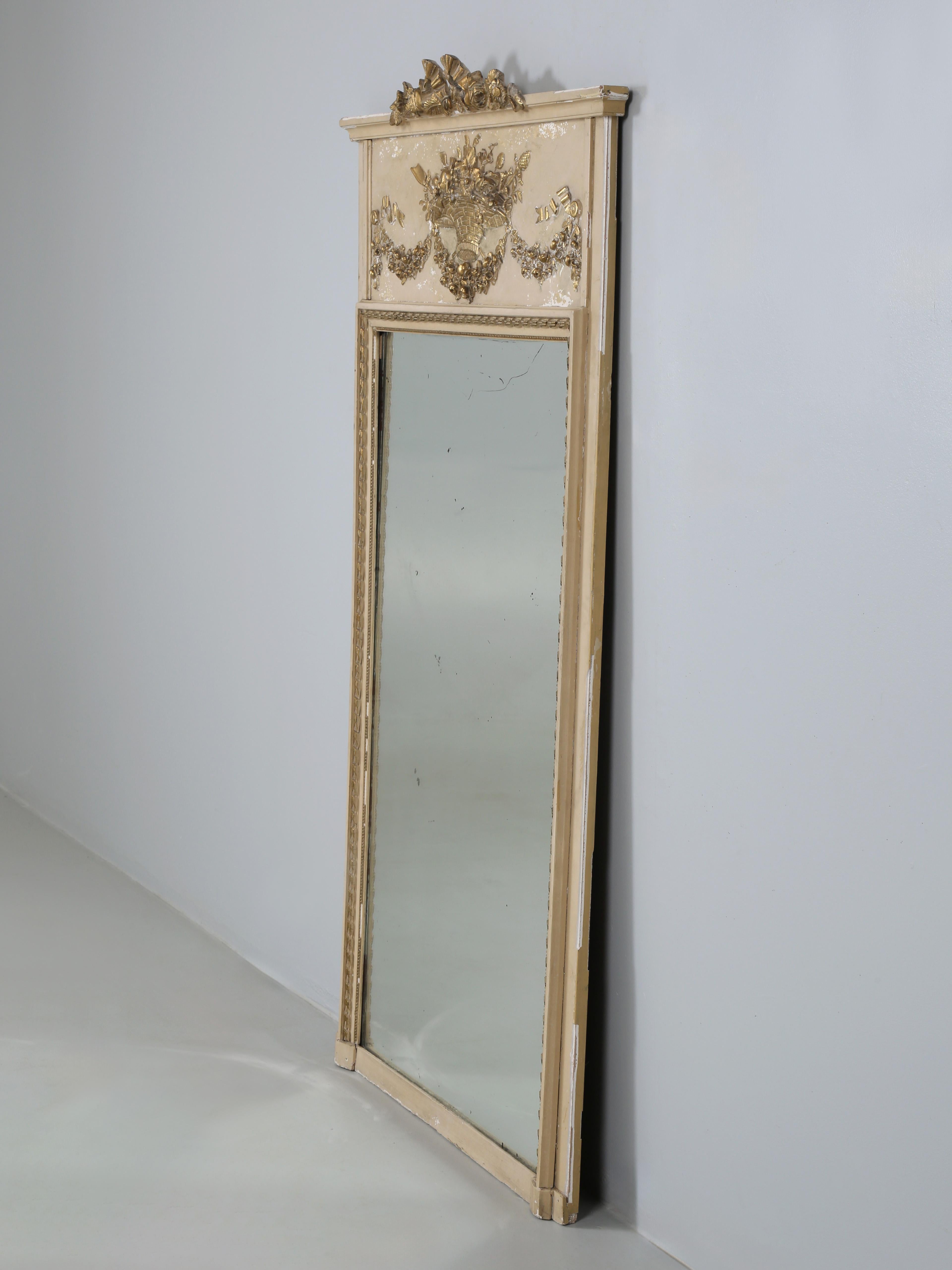 French Antique Trumeau Mirror still with its original beautiful aged glass. The entire Antique French Trumeau remains completely unrestored and shows it age gracefully. Our Old Plank finishing department can restore the Antique French Trumeau upon