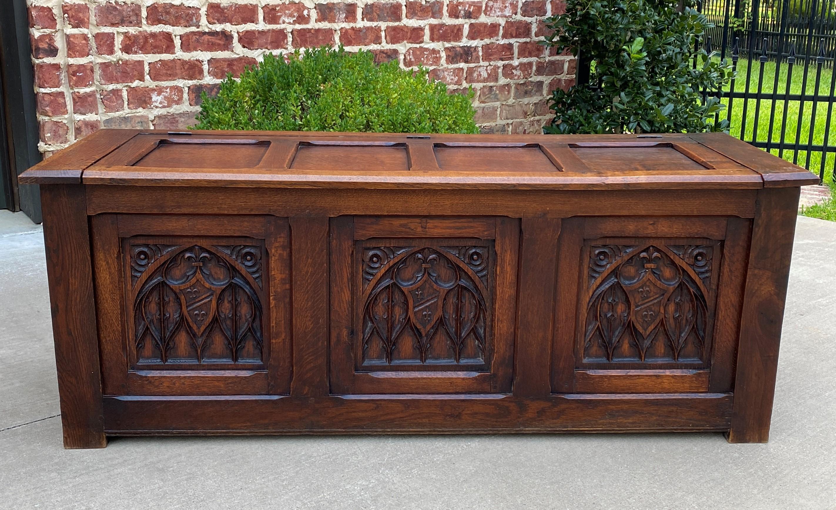 Wonderful antique French oak trunk, blanket box, storage chest, or coffee table

Carved heraldic shields with Gothic tracery and rosette accents

Use for storage of blankets, games or linens~~the possibilities are endless! 

Measures: 20.5