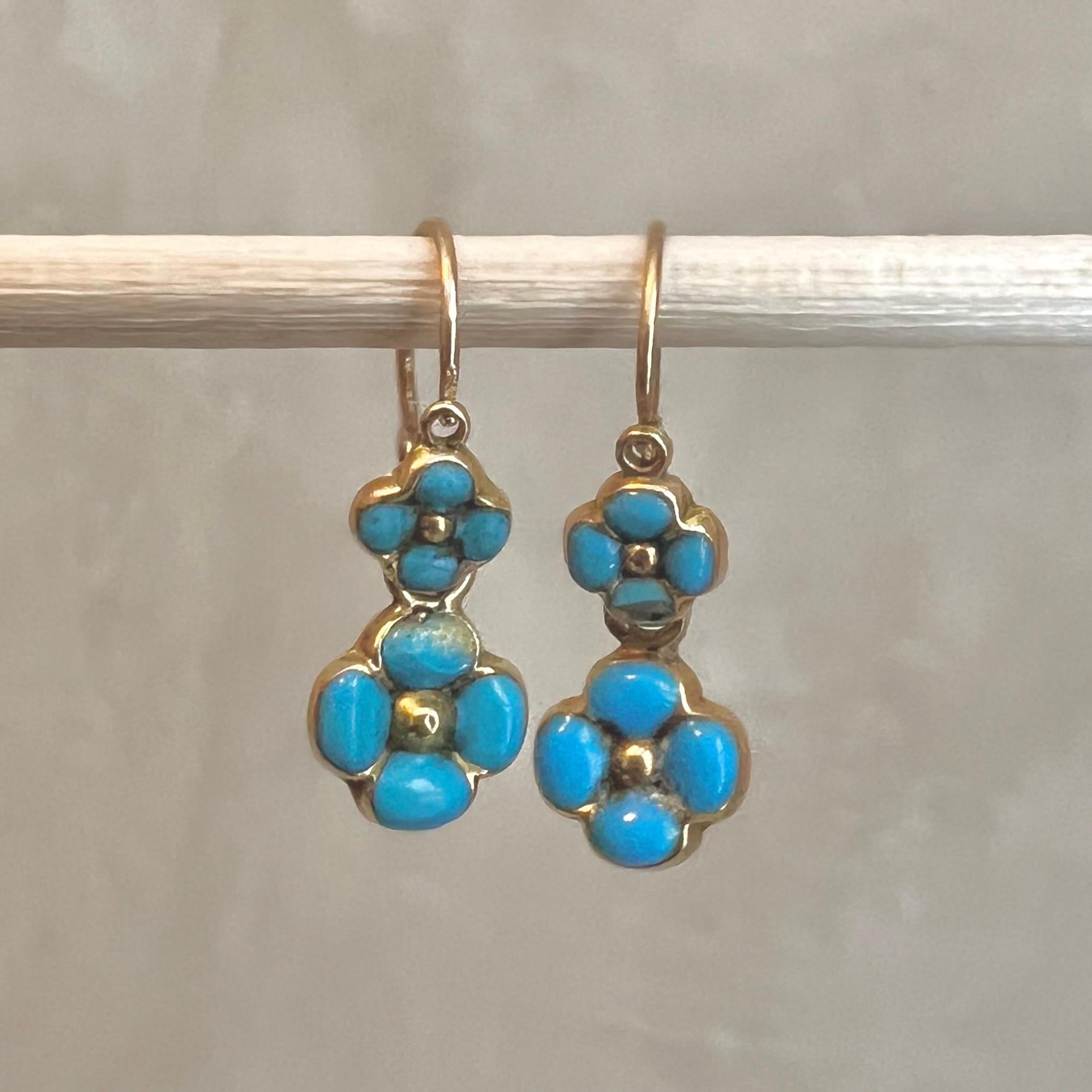A pair of 18 karat yellow gold and turquoise enamel forget-me-nots drop earrings. 

Adorn yourself with these amiable antique turquoise enamel and gold flower earrings. Crafted from 18 karat yellow gold and hallmarked with the French 