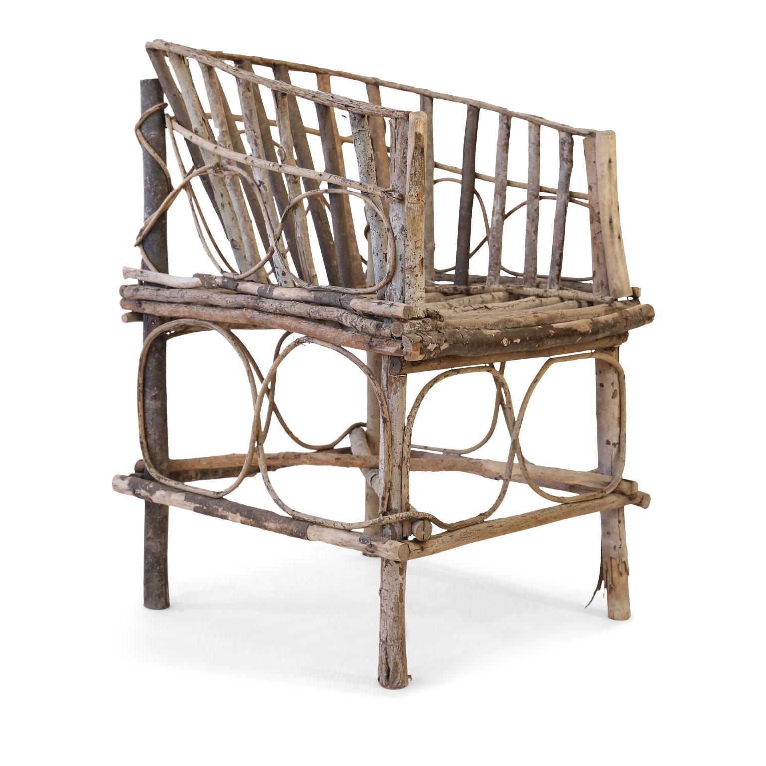 Antique rustic French twig chair: 19th century or early 20th century Tramp Art chair constructed by hand from branches and twigs by an unknown itinerant folk artist. Retains a beautiful natural, pale patina.
 