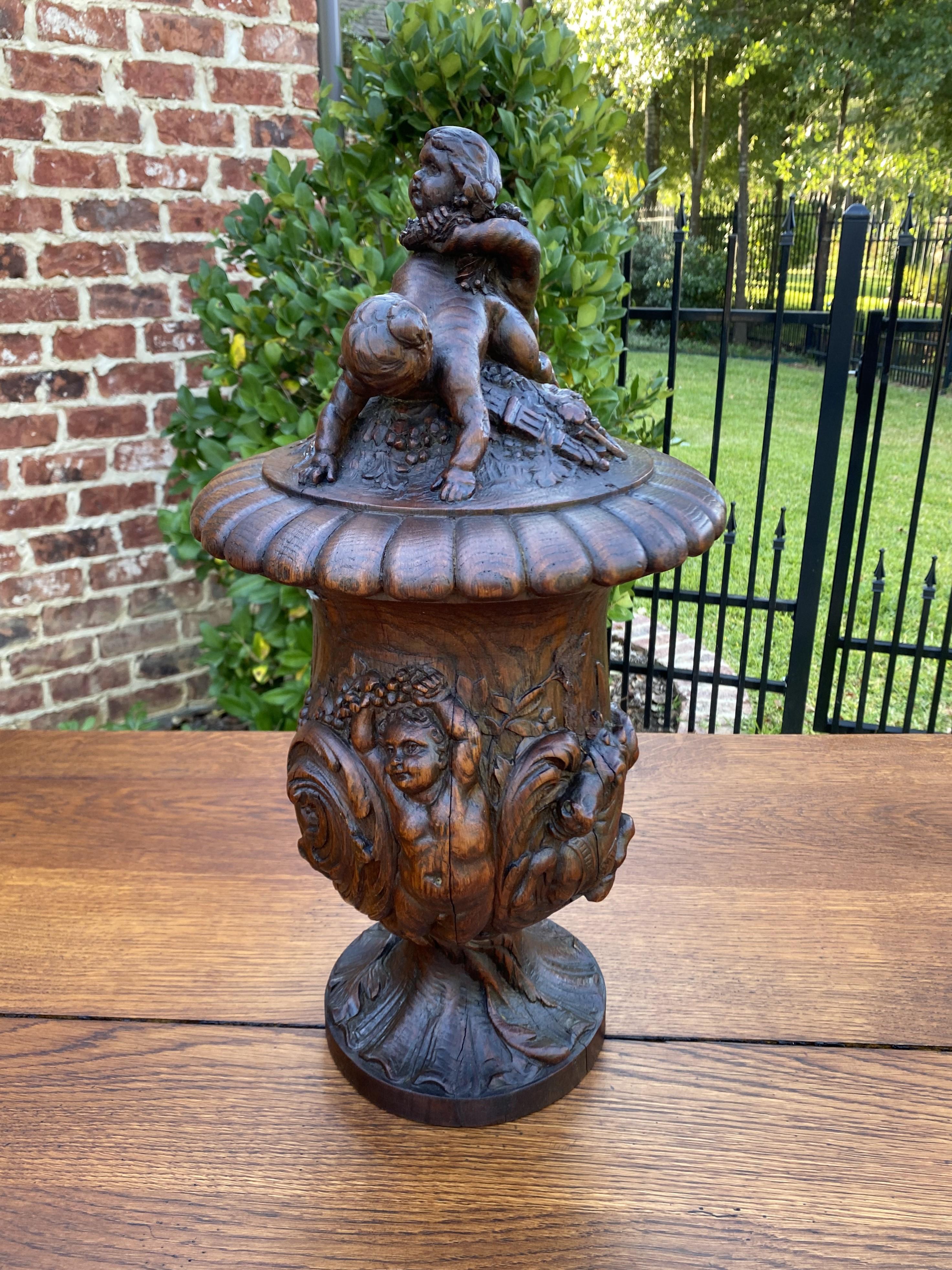 Exquisite antique French urn~~highly carved oak cherubs, putti, hippocamp and acanthus accents~~c. 1880s

A must see~~stunning hand-carved french oak urn~~affixed lid with carved cherubs and pedestal base~~rarely do we find such a gorgeous piece