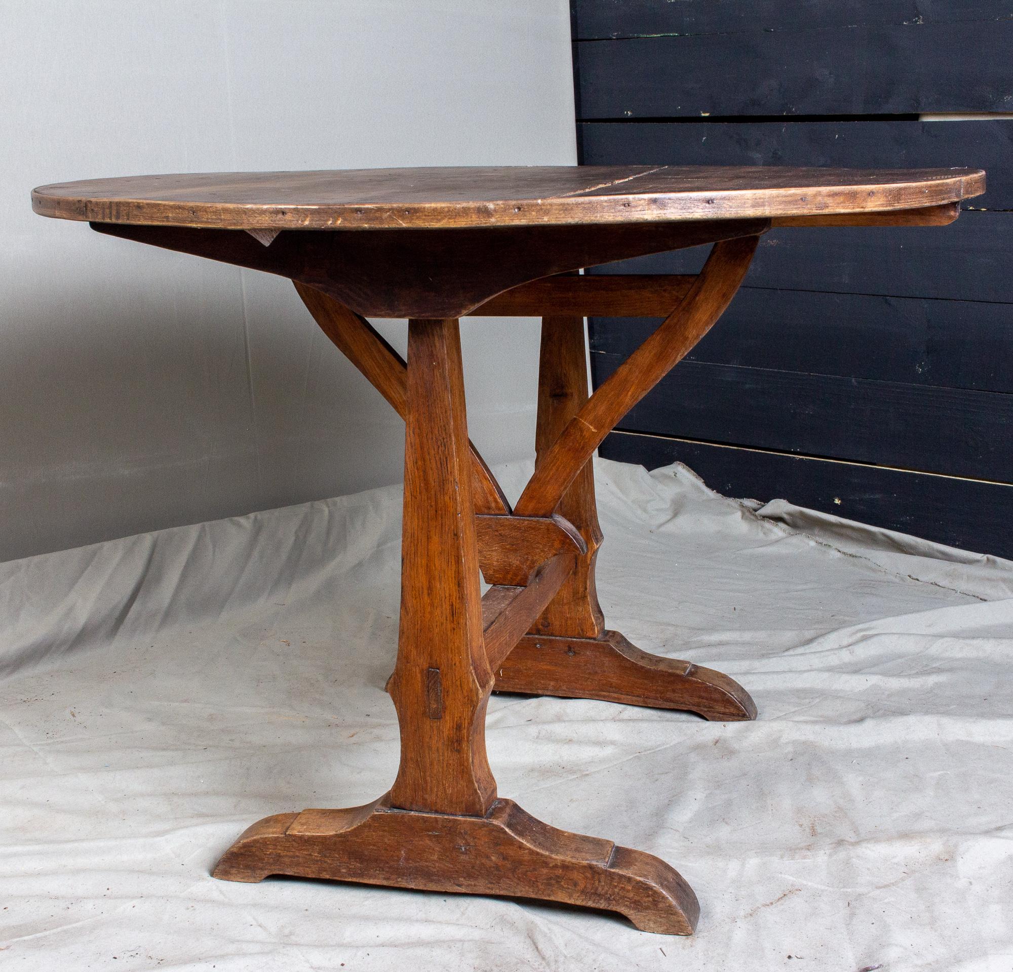 During the harvest, the French winemakers and farmers often used tables such as these to break bread in the fields, so they could remain near the crops and work as efficiently as possible. This particular table features a worn finish with variations