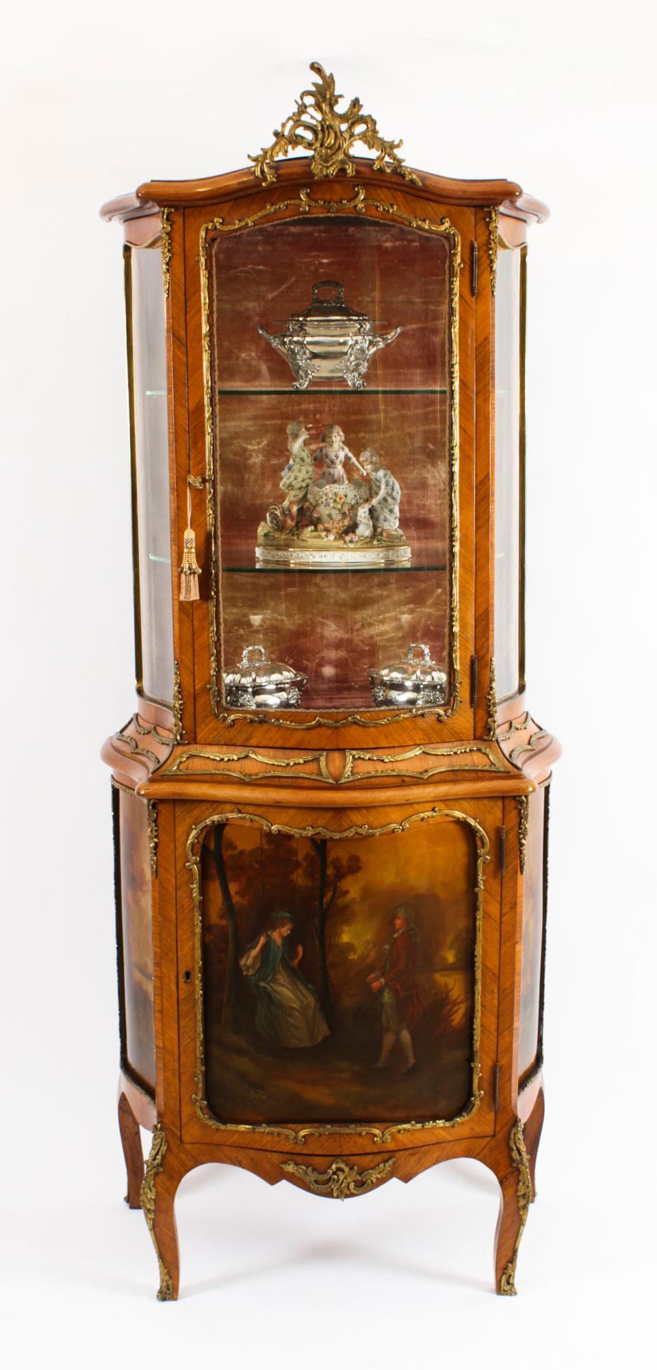 This is a stunning antique French wood and Vernis Martin vitrine cabinet, in the Louis XV manner, Circa 1880 in date, with exquisite hand painted decoration and exquisite ormolu mounts.

The top has serpentine glass sides with a central bow glazed