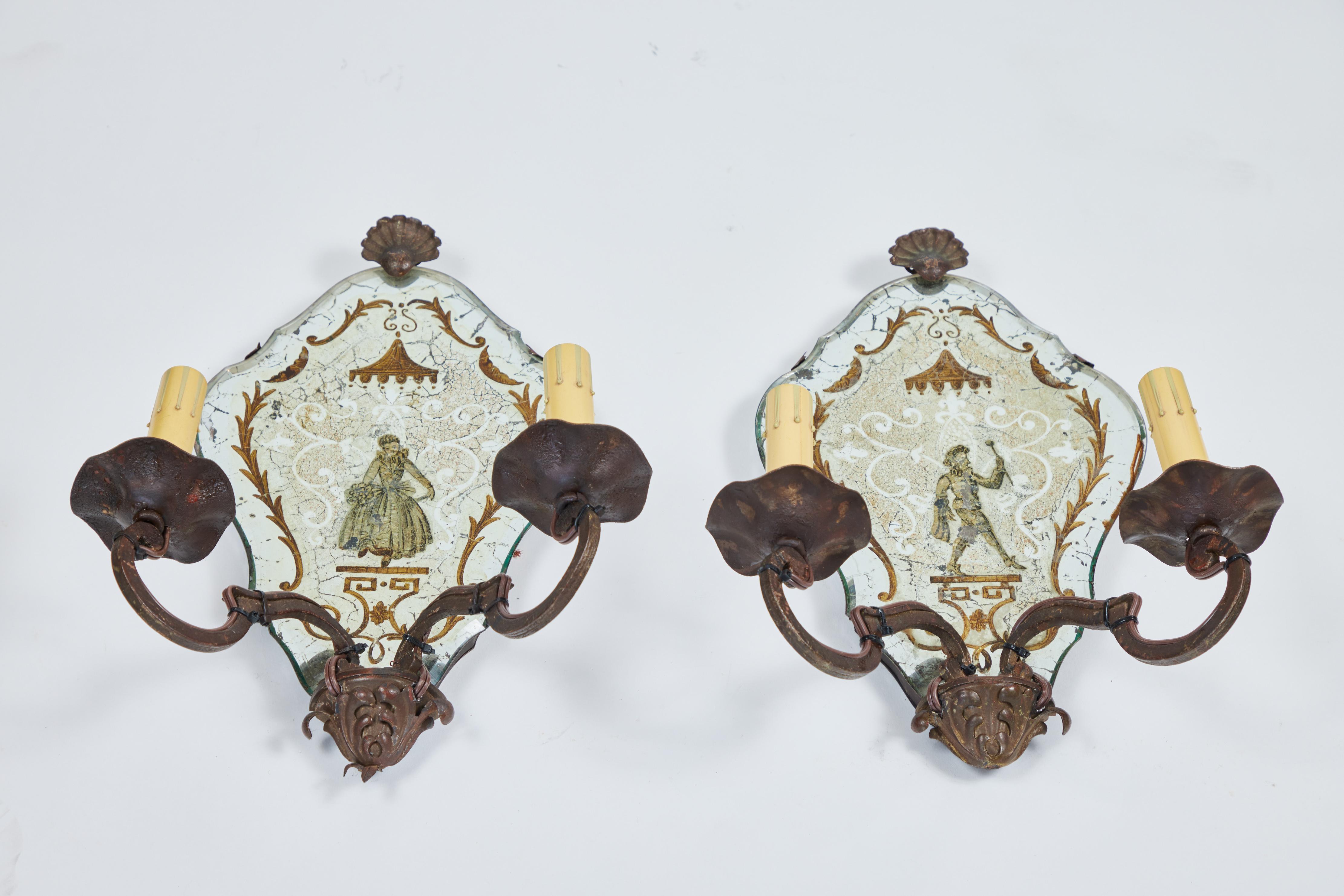 These sconces have beautifully beveled mirror panels gilded with gold leaf, have hand painted gold border and man / woman on reverse side and have been newly rewired.


 