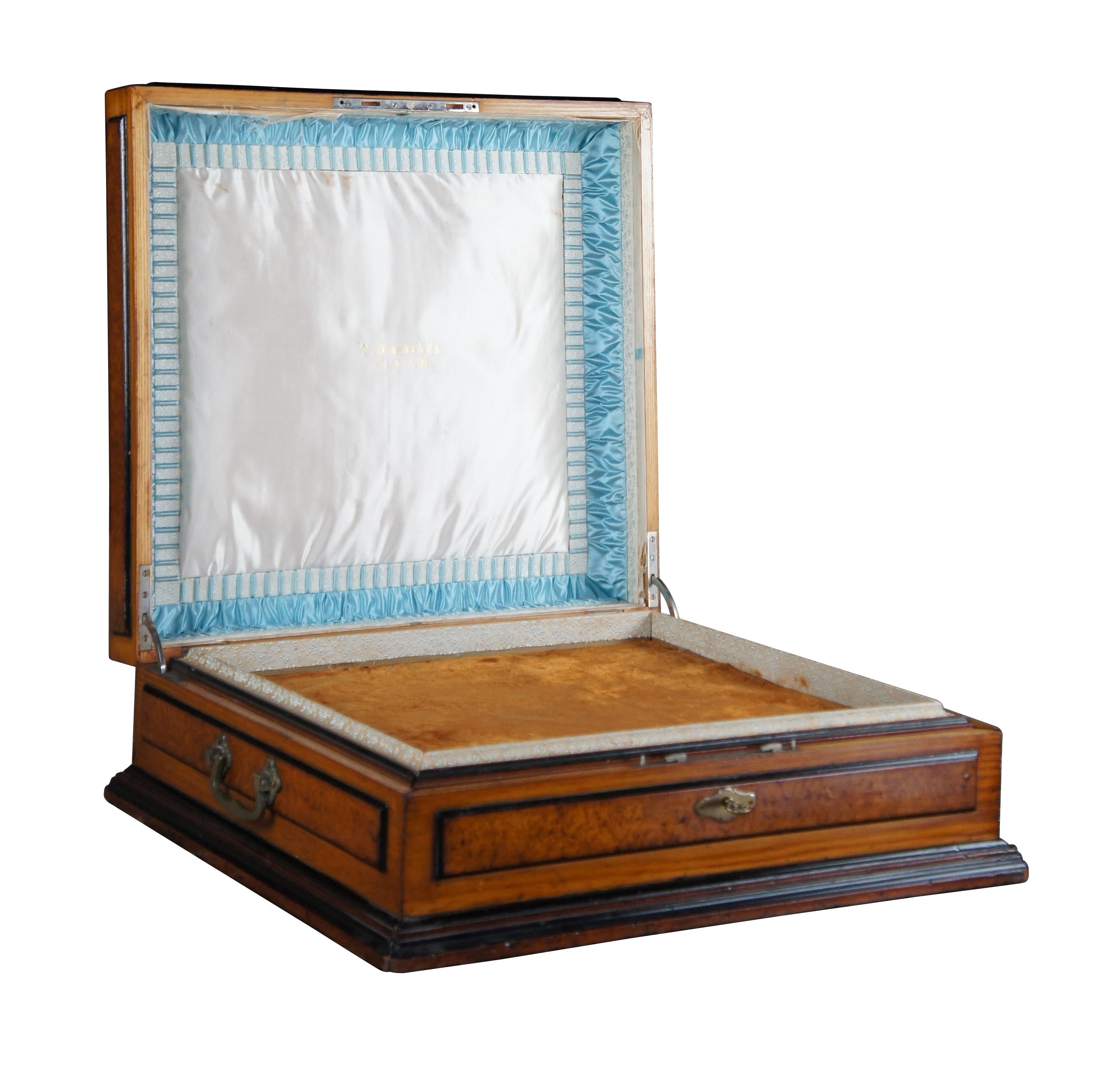 An exceptional large wooden case from the Victorian era, circa 1880s. Made from pine with raised and burled panels. Features a marquetry inlay top showcasing a bird within a flowering branch, framed in filigree inlay with a mother of pearl edge. The