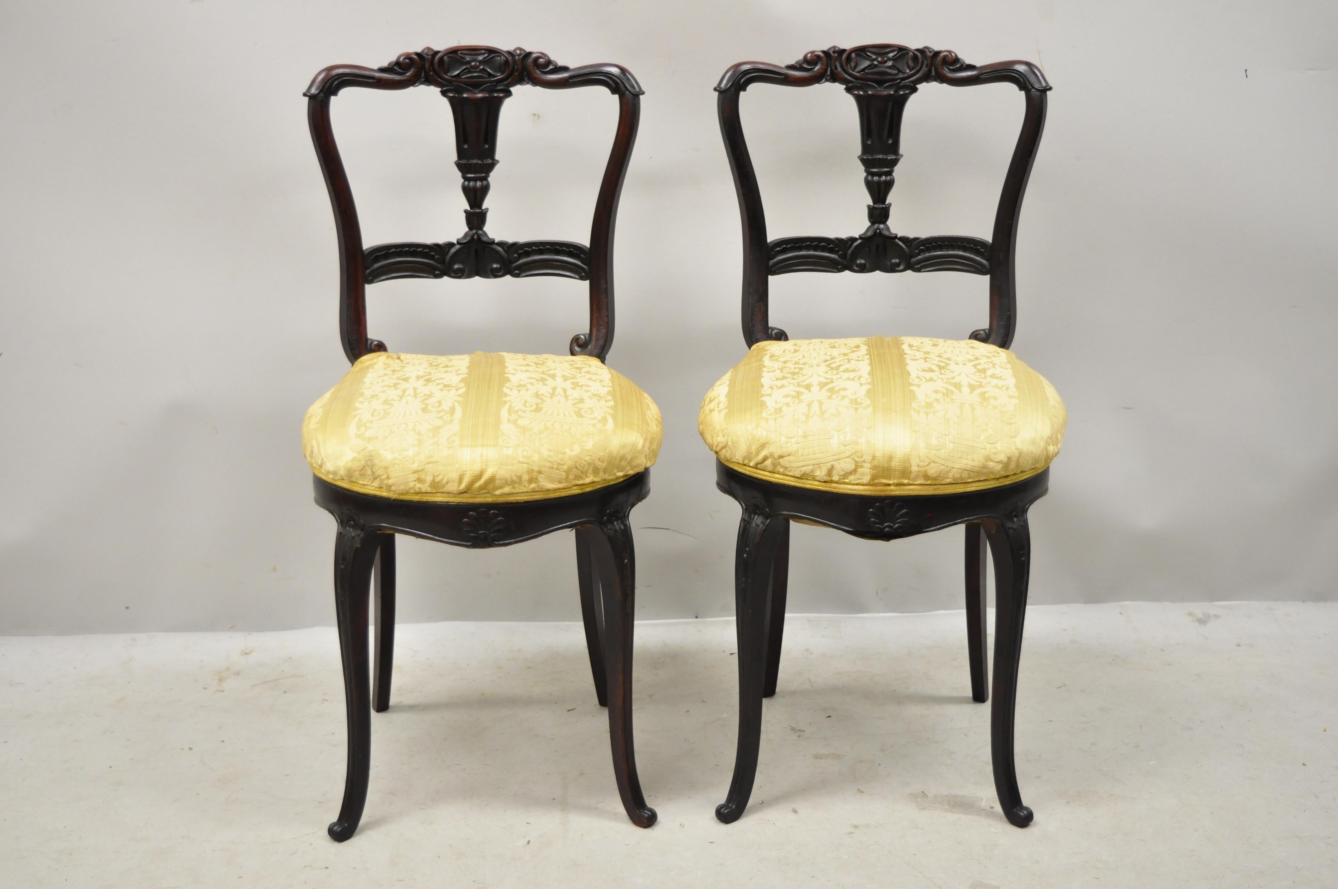 Antique French Victorian carved rosewood small petite accent side chairs - a pair. Item features a small petite size, beautiful dark rosewood frames, upholstered seats, nicely carved details, petite cabriole legs, very nice antique pair,
circa
